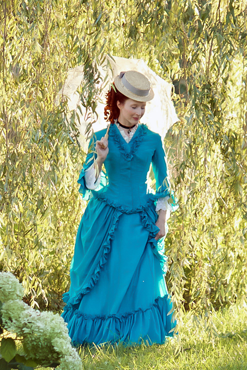 1870s Silk/Cotton Voile Gown: A light summery late Early Bustle period gown with a fitted bodice and gathered flounce detailing. Enquire for Couture pricing.