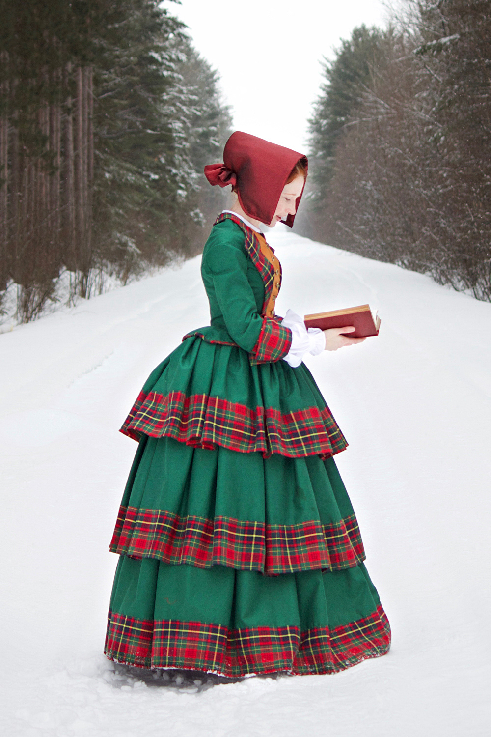 An early 1850s cotton gown with a tiered skirt worn over a corded petticoat.