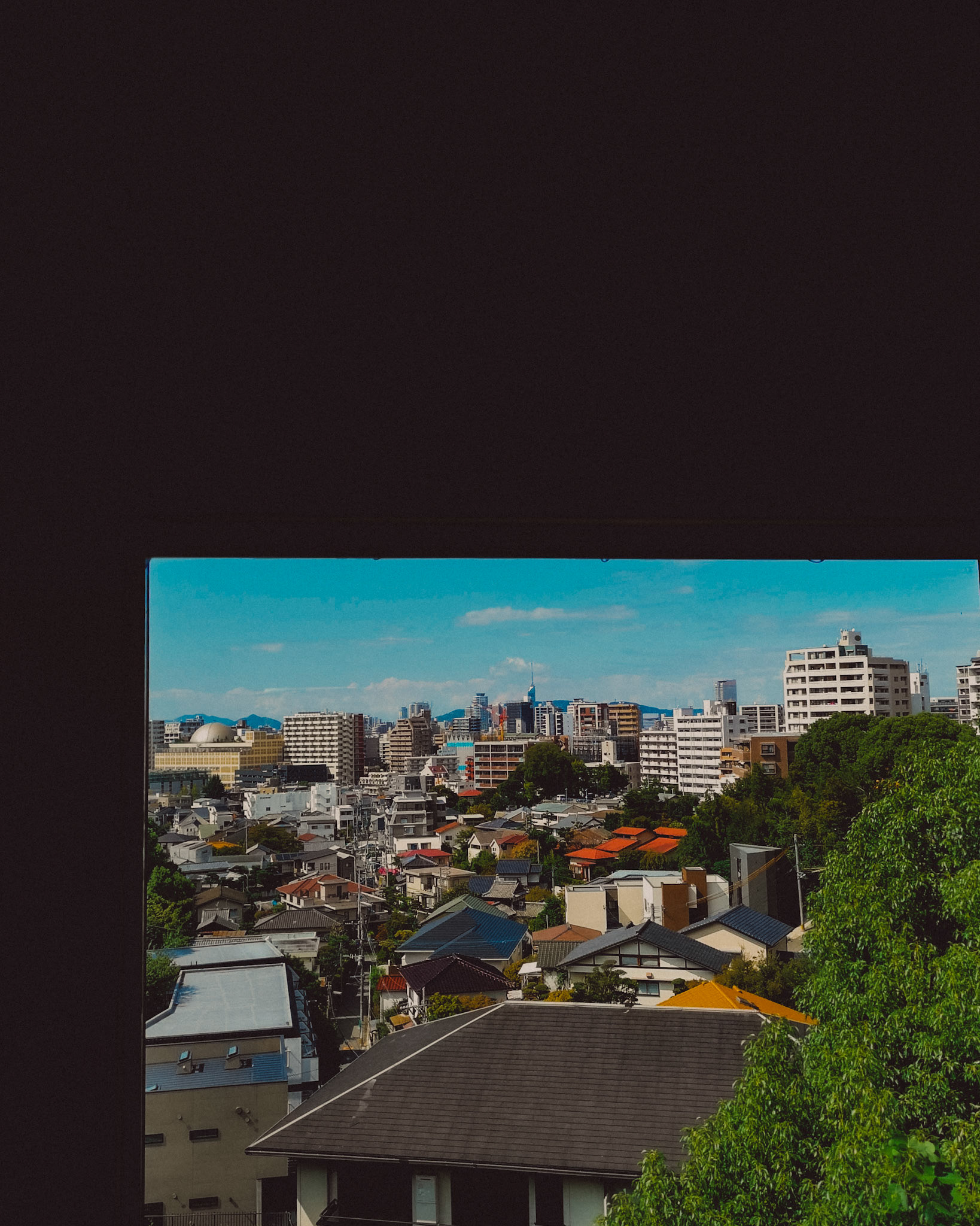 The city's skyline from IMURI with Fukuoka Tower in the background, framed within a window sill, Fukuoka, Japan, October 2018, Huawei P20 Pro.