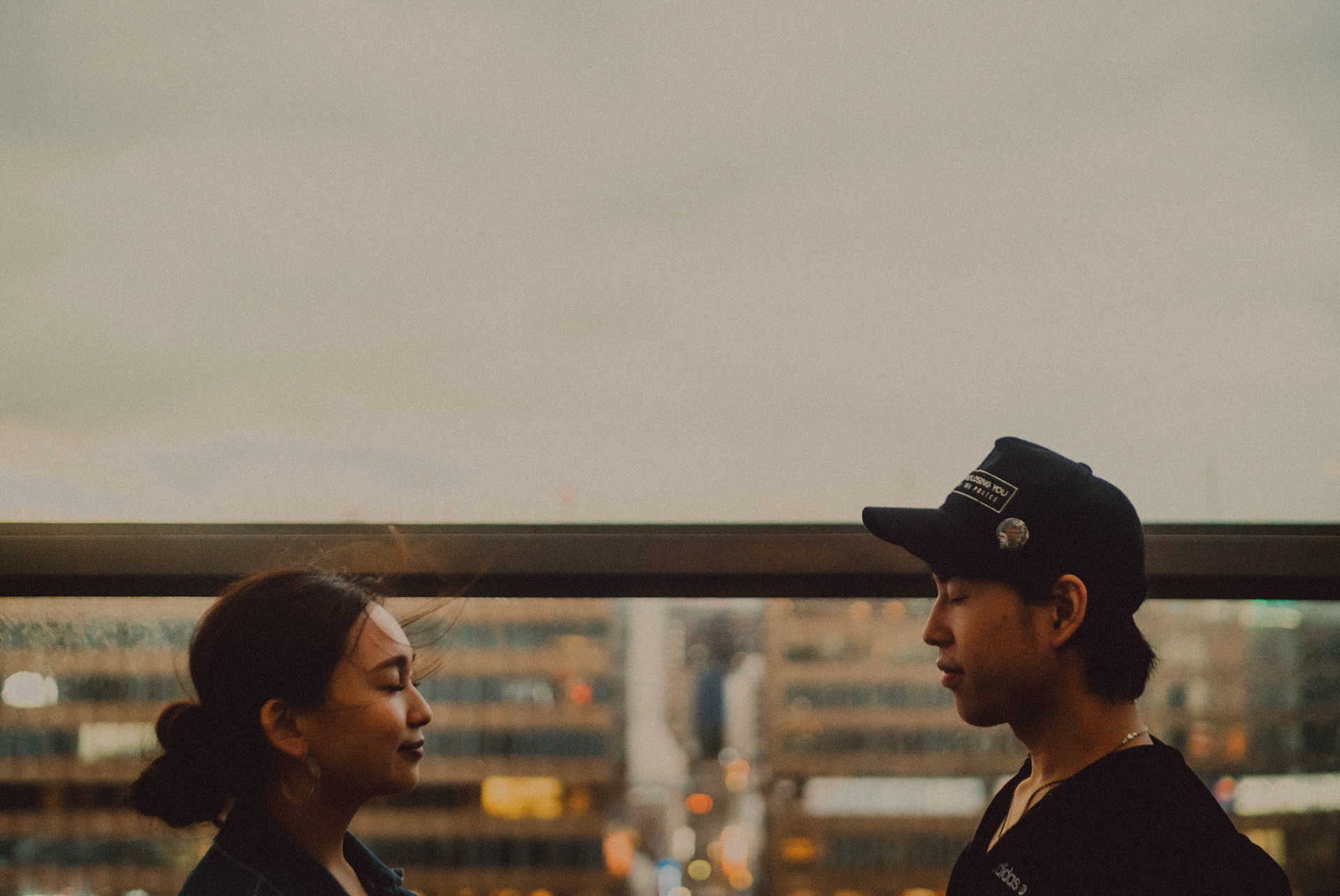 Moody pre-wedding and engagement portraits at AMU Plaza's roofdeck overlooking Fukuoka, Japan, October 2018, Sony A7SII.