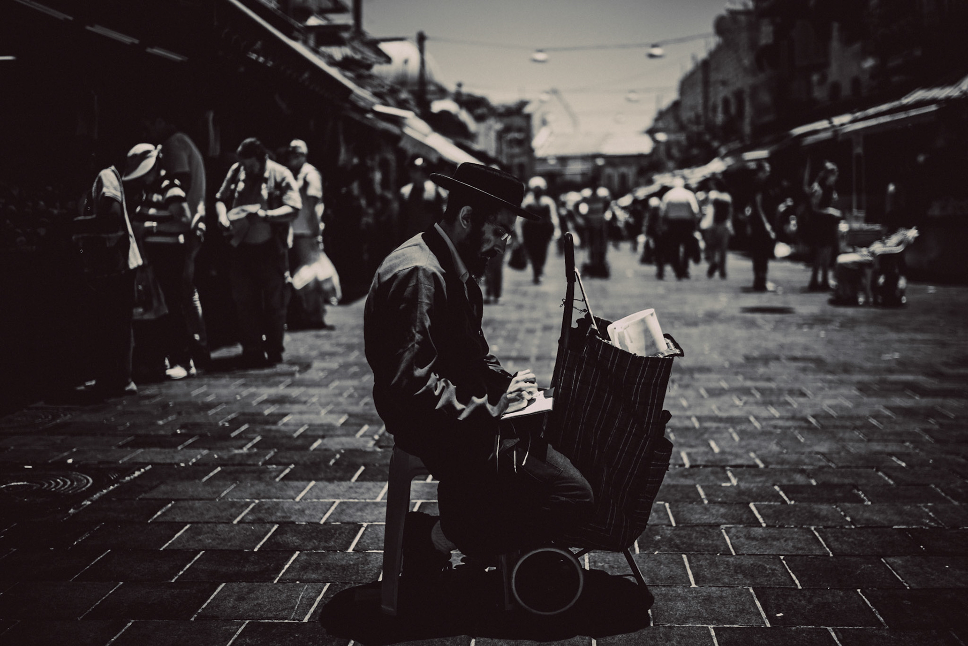 A Jewish man in the middle of Mahane Yehuda Market, in black and white, Jerusalem, Israel, July 2015, Leica M.
