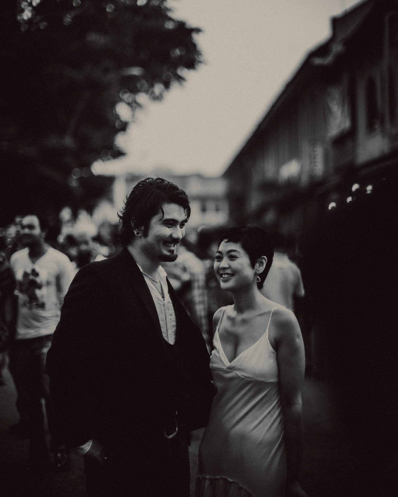 A candid, reportage-style engagement shoot in Little India on a Sunday afternoon feauring a Japanese couple, in black and white, Farrer Park, Singapore, October 2015, Leica M.