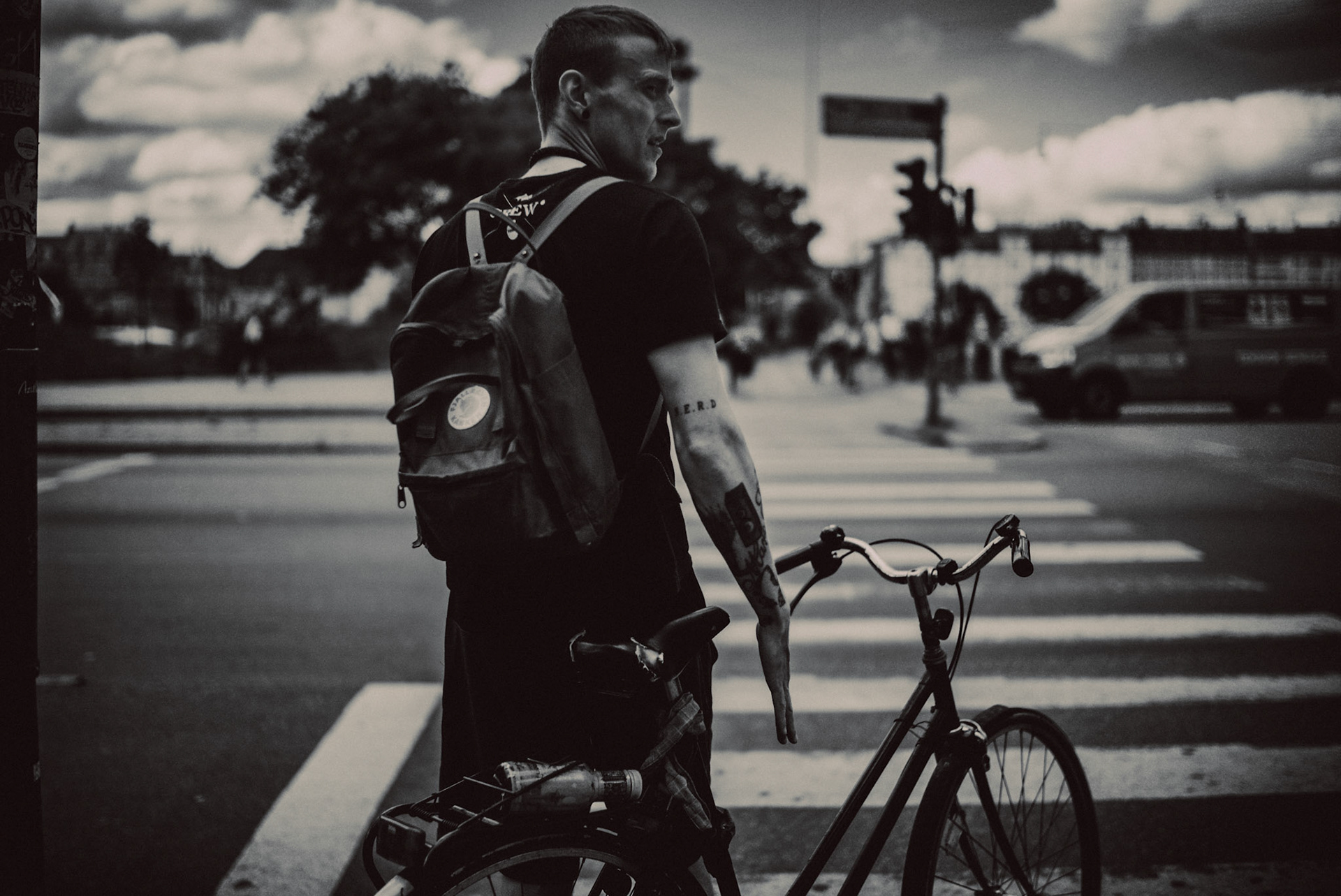 A Danish man with tattoos, wearing a brown Fjallraven Kanken backpack, Vesterbro, Copenhagen, Denmark, August 2015, Leica M.