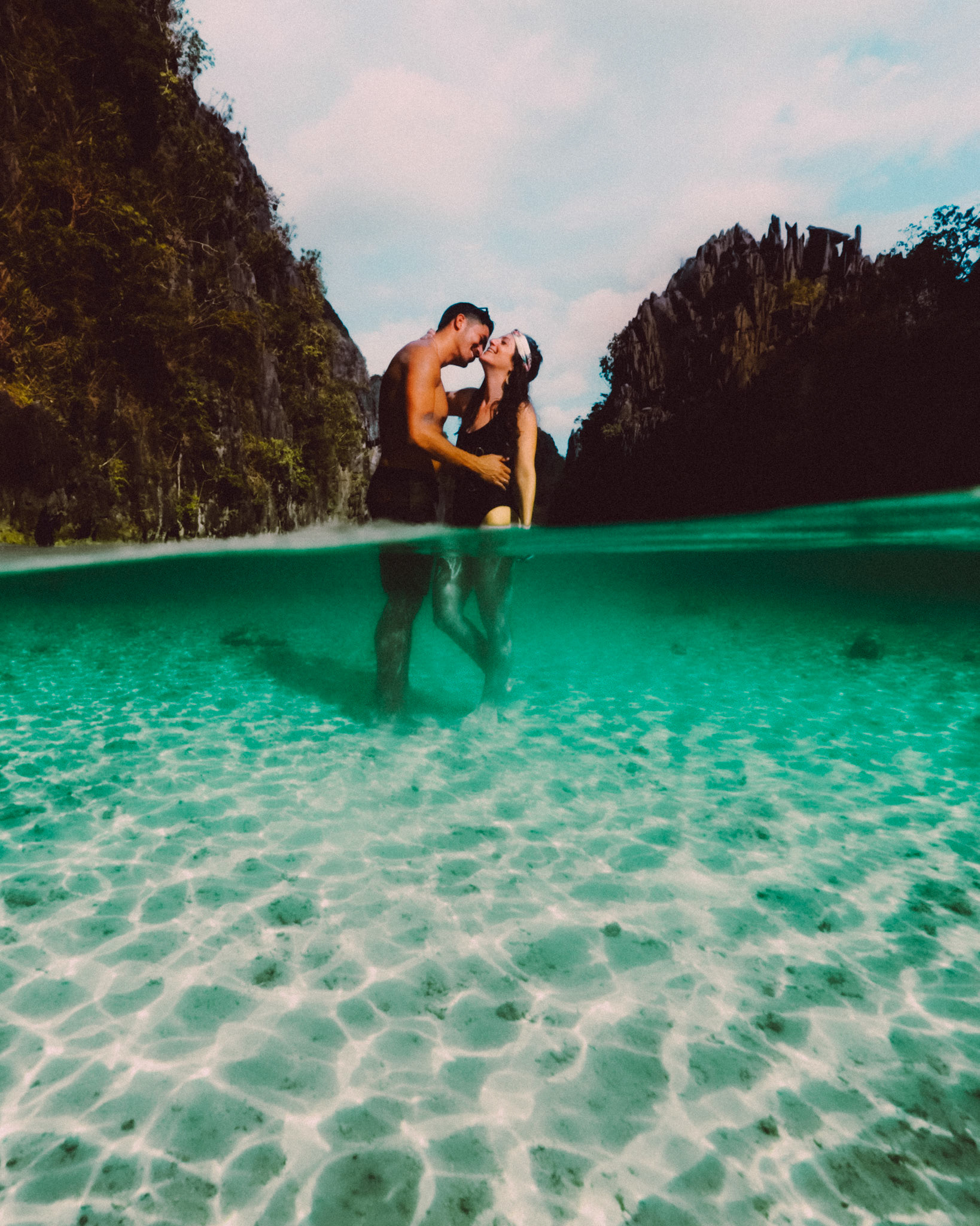 The couple wading waist-deep water in the Big Lagoon, from Peter &amp; Alexis' adventure engagement session in Miniloc Island, El Nido, Palawan, Philippines, Southeast Asia, April 2018, Sony A7SII