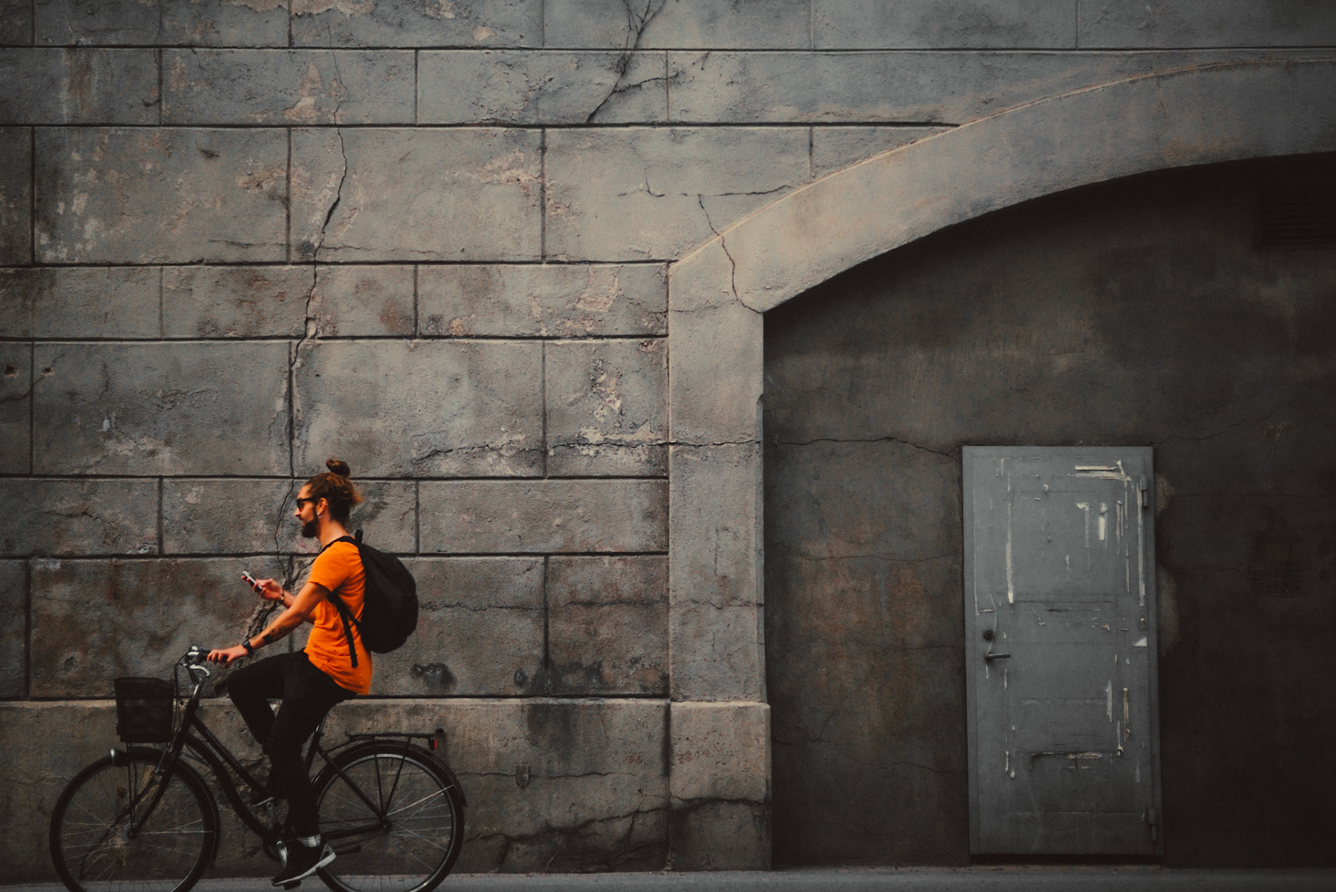 A biker wearing an orange shirt in the Hornsgatan area, Stockholm, Sweden, July 2016, Leica M.