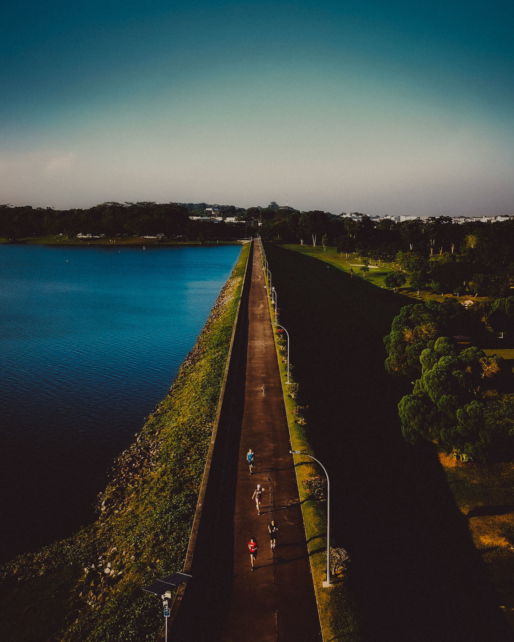 Joggers in a perspective photo of Upper Selatar Reservoir, Singapore, August 2018, Huawei P20 Pro.
