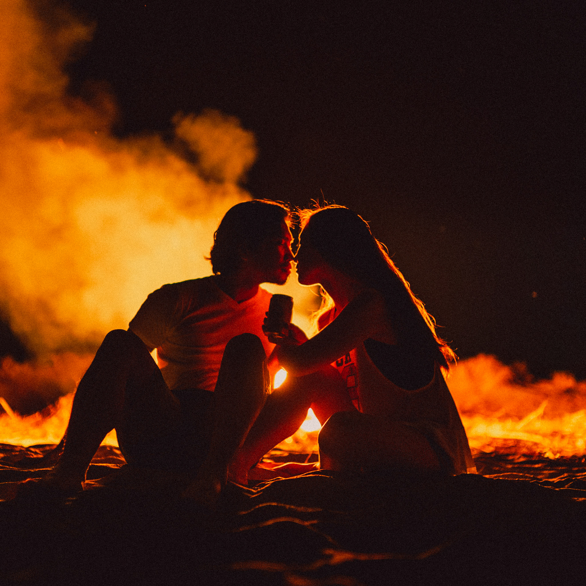 Moody and intimate couple portraits beside a bonfire, from Koke and Pam's chill and outdoorsy prenup photoshoot in Bonuan Beach, Dagupan, Pangasinan, Philippines, Southeast Asia, November 2015, Sony A7S.