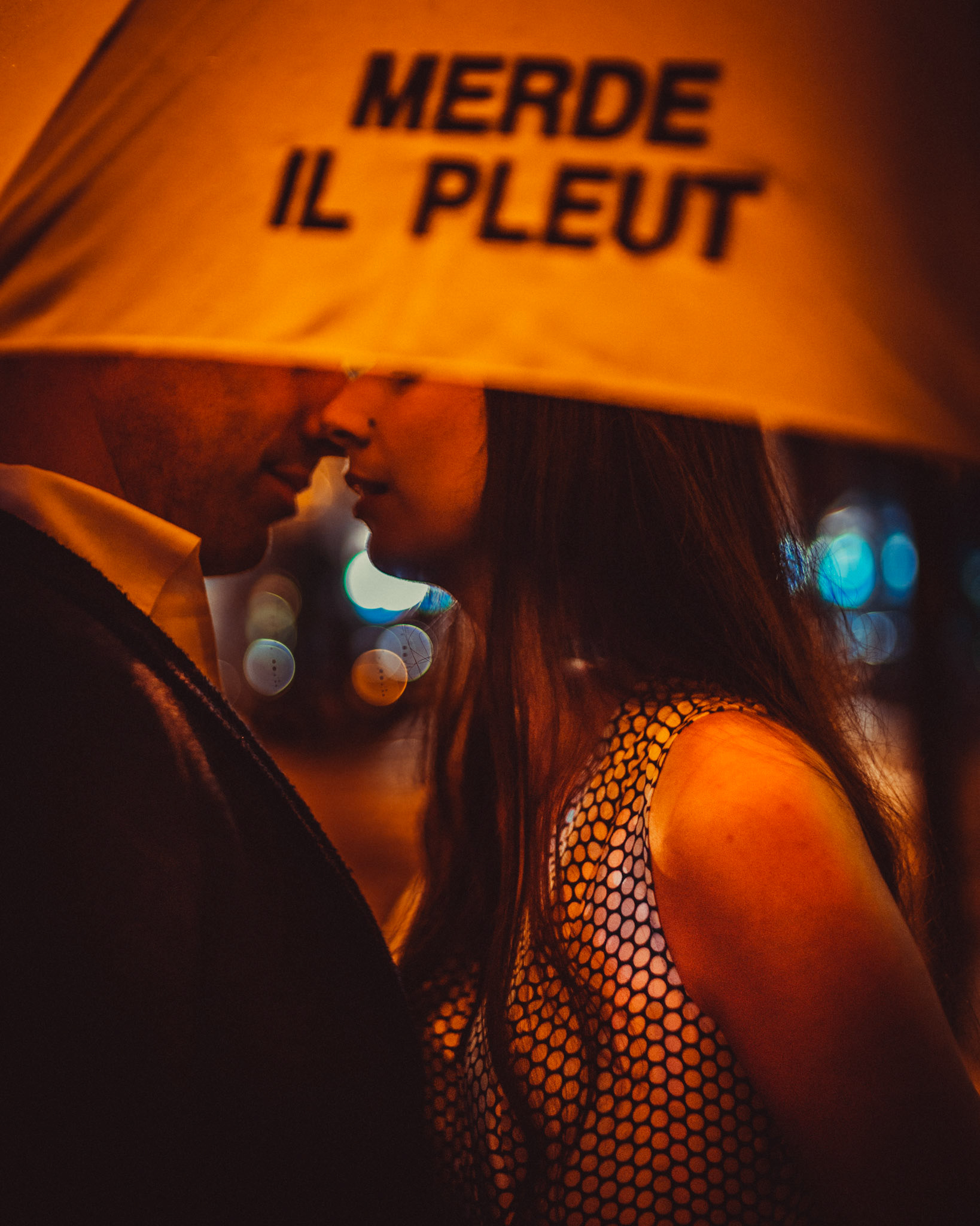 A moody and intimate late night urban engagement shoot with the couple under a bright yellow Merde Il Pleut umbrella, from Eric and Sabrina's prewedding shoot in Central, Hong Kong, April 2019, Sony A7III.