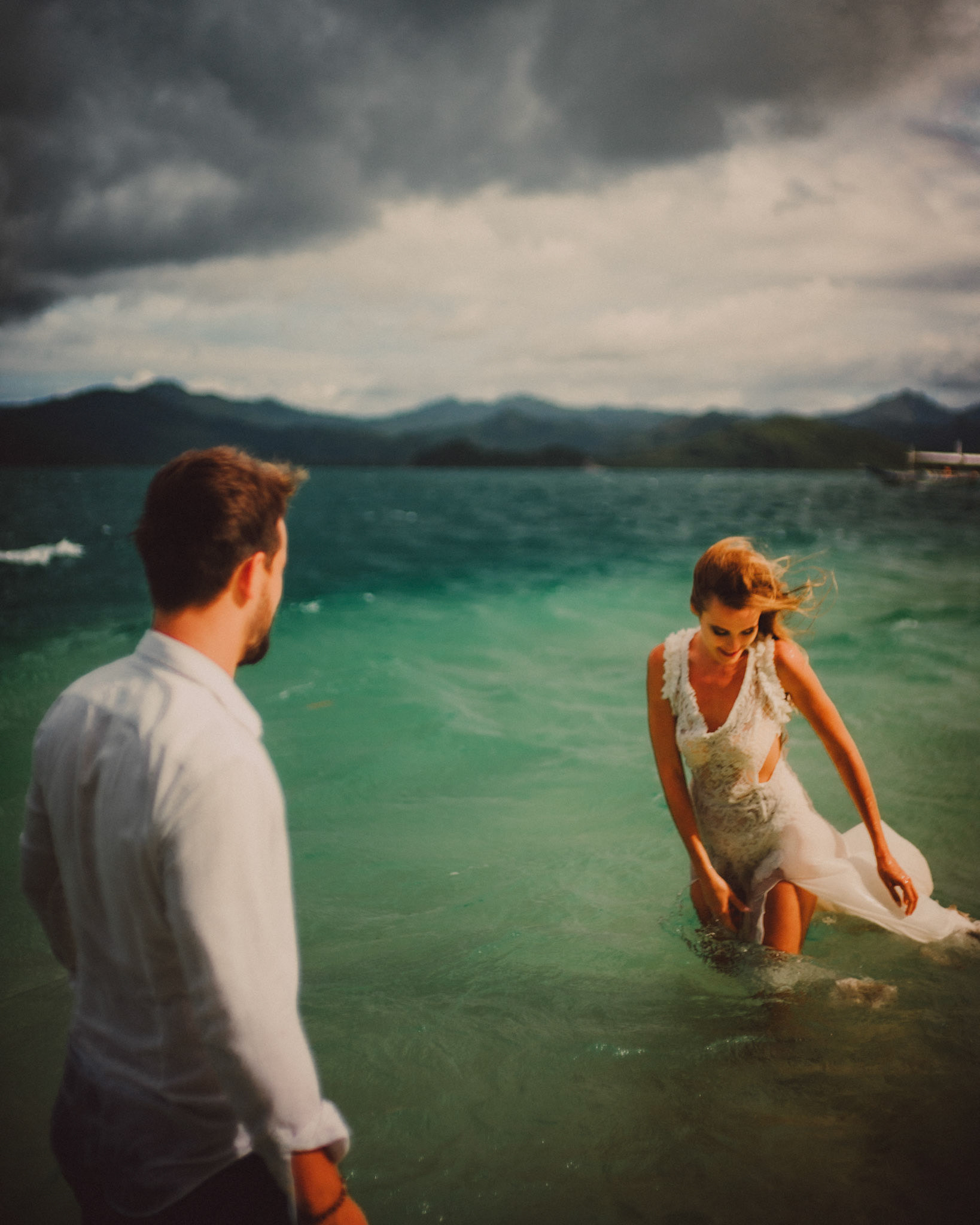 Candid couple portraits in knee-deep turquoise blue water, Pinagbuyutan Island, El Nido, Palawan, Philippines, Southeast Asia, December 2019, Sony A7III.