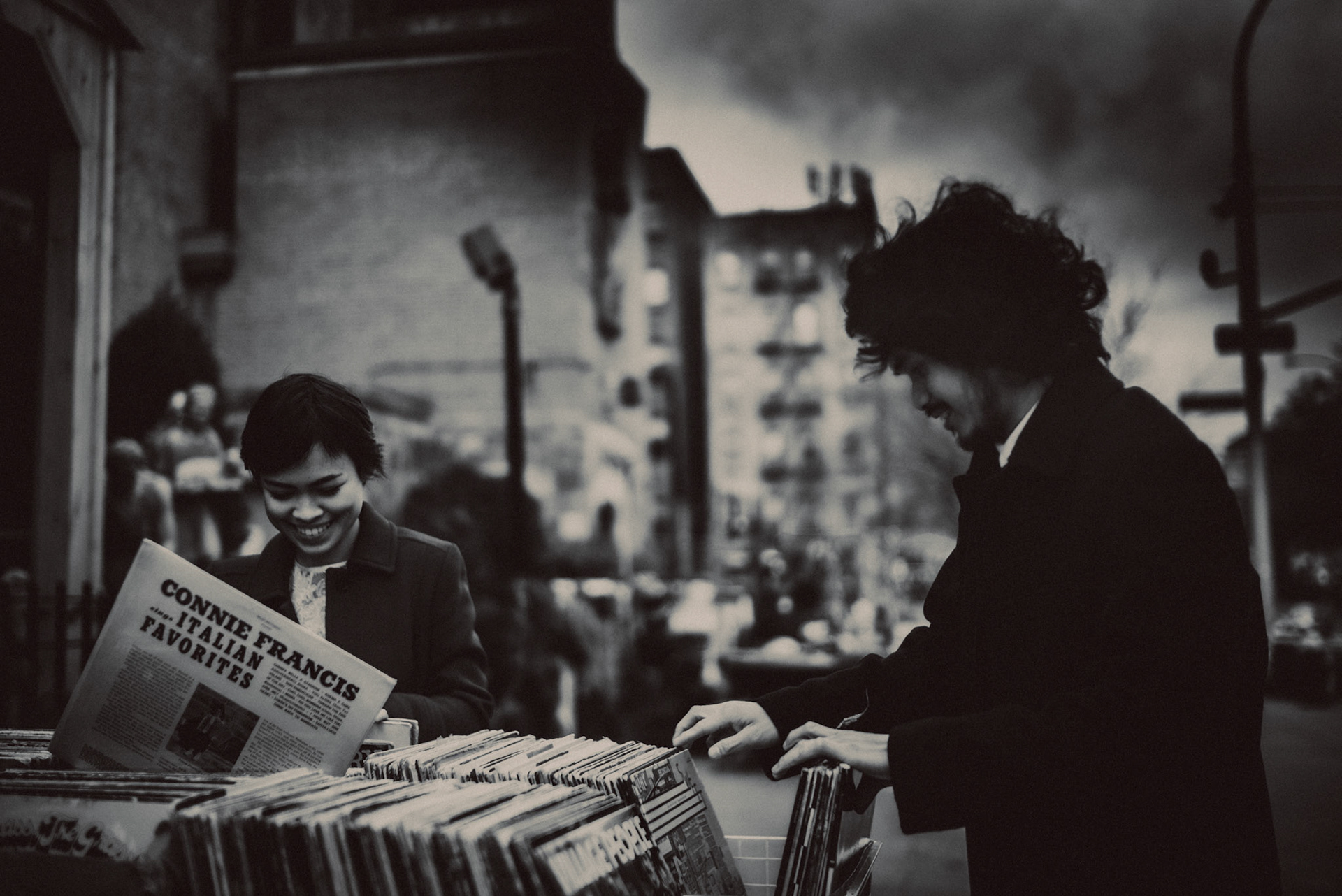 Vinyl record hunting along W Houston, from AC &amp; Winona's casual and chill engagement shoot in Manhattan, New York City, USA, December 2017, Leica M.