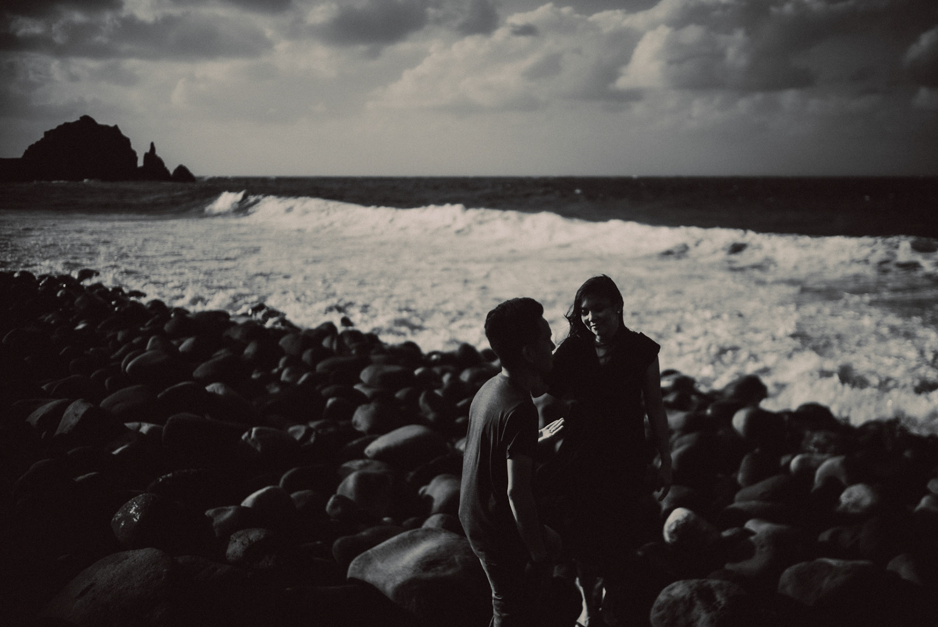 Moody couple portraits, in black and white, from Owen and Nikka's adventure prenup photoshoot in Chadpidan Boulder Beach, Batanes, Philippines, October 2017, Leica M.