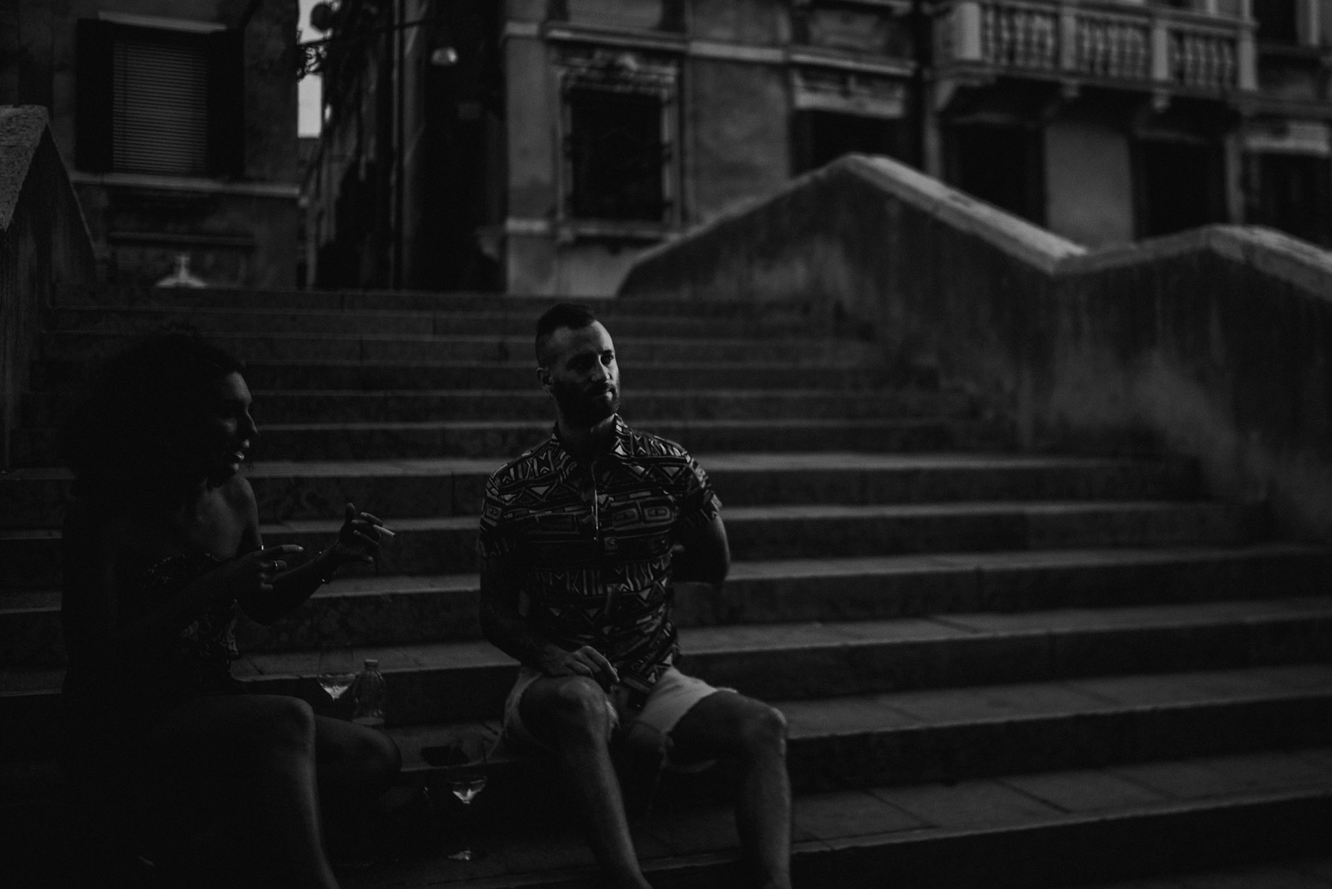 A man and woman sitting on a bridge, Ponte delle Guglie in Venice, Italy, August 2017, Leica M.