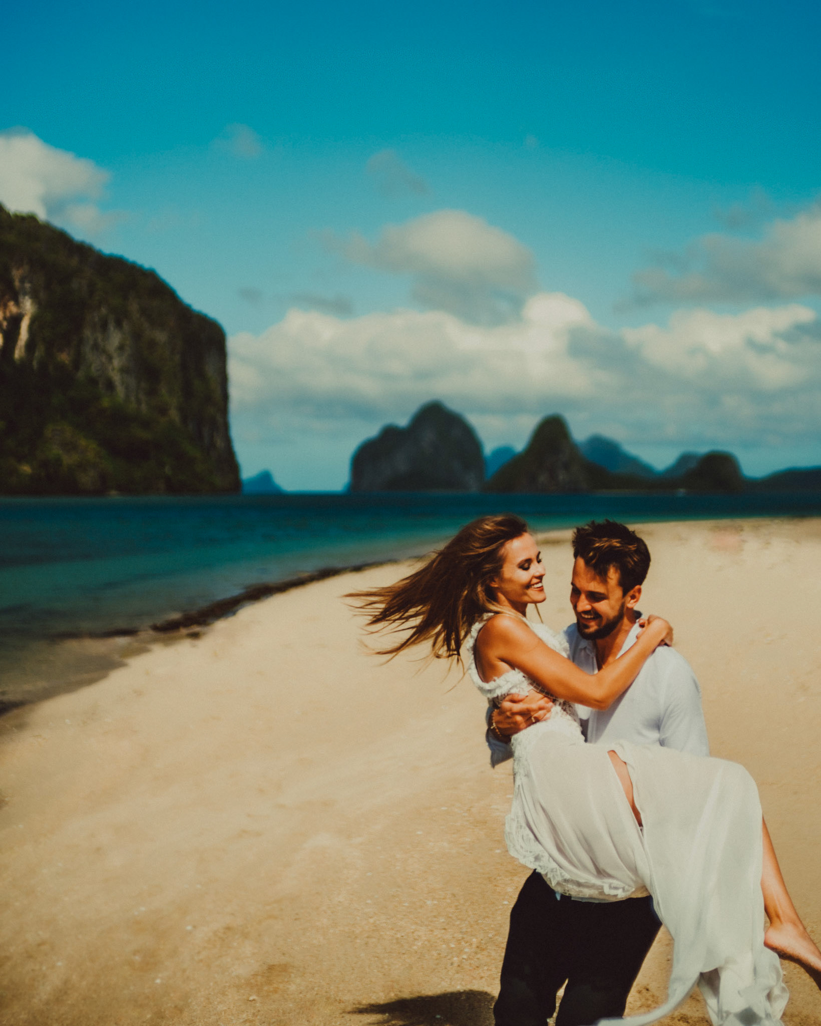 A honeymoon couple shoot in Lagen Island's sandbar on a bright and sunny morning, El Nido, Palawan, Philippines, Southeast Asia, December 2019, Sony A7III.