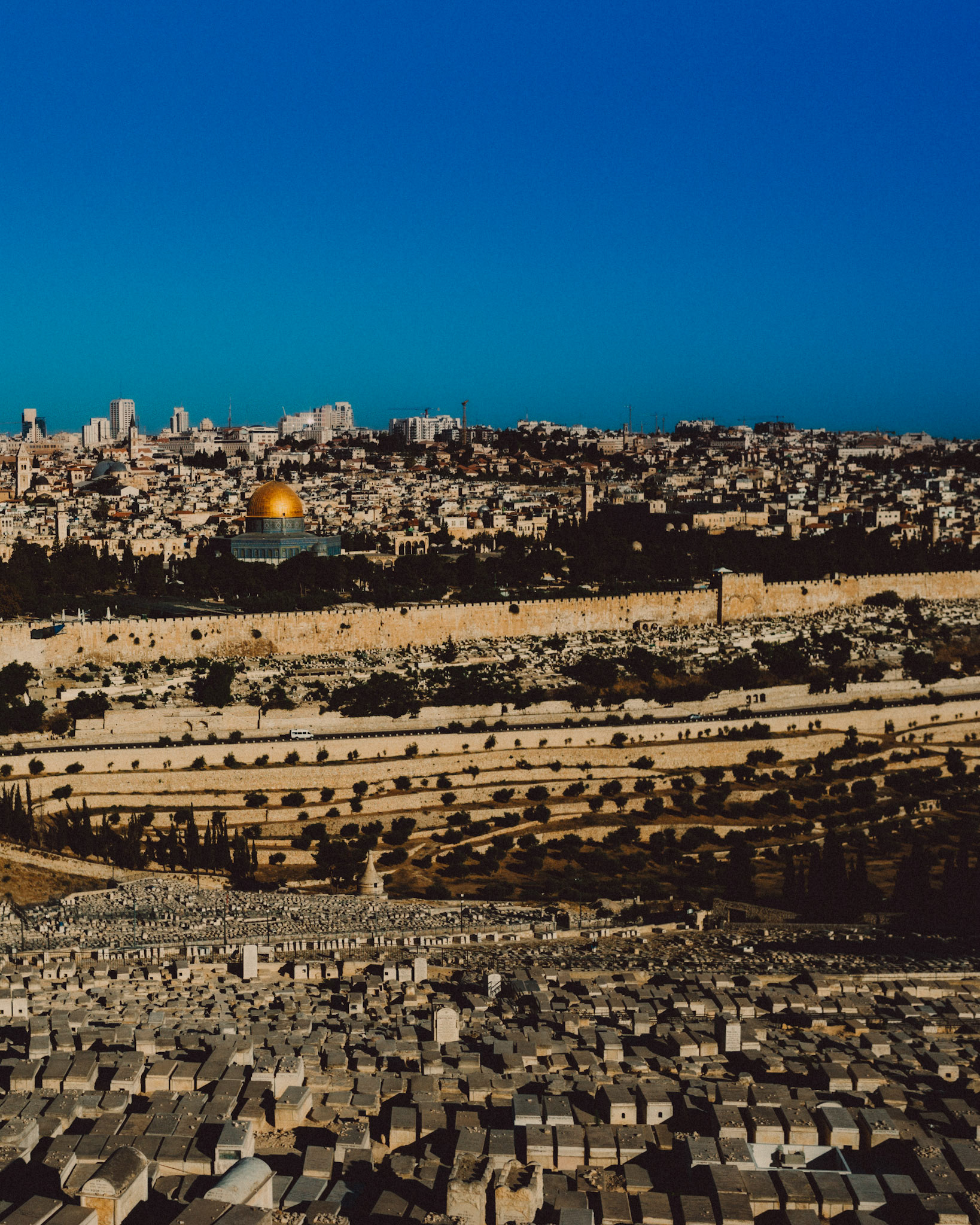 The temple mount, the Dome of the Rock, and the Kidron Valley, with tombstones in a Jewish cemetry in the foreground, Jerusalem, Israel, July 2015, Leica M.