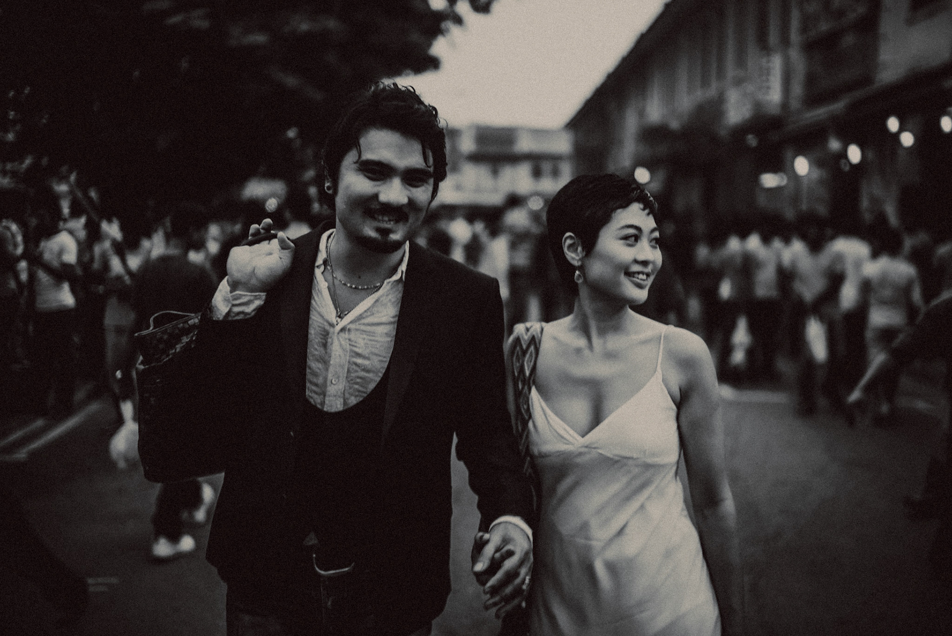A candid, reportage-style engagement shoot in Little India on a Sunday afternoon feauring a Japanese couple, in black and white, Farrer Park, Singapore, October 2015, Sony A7S.