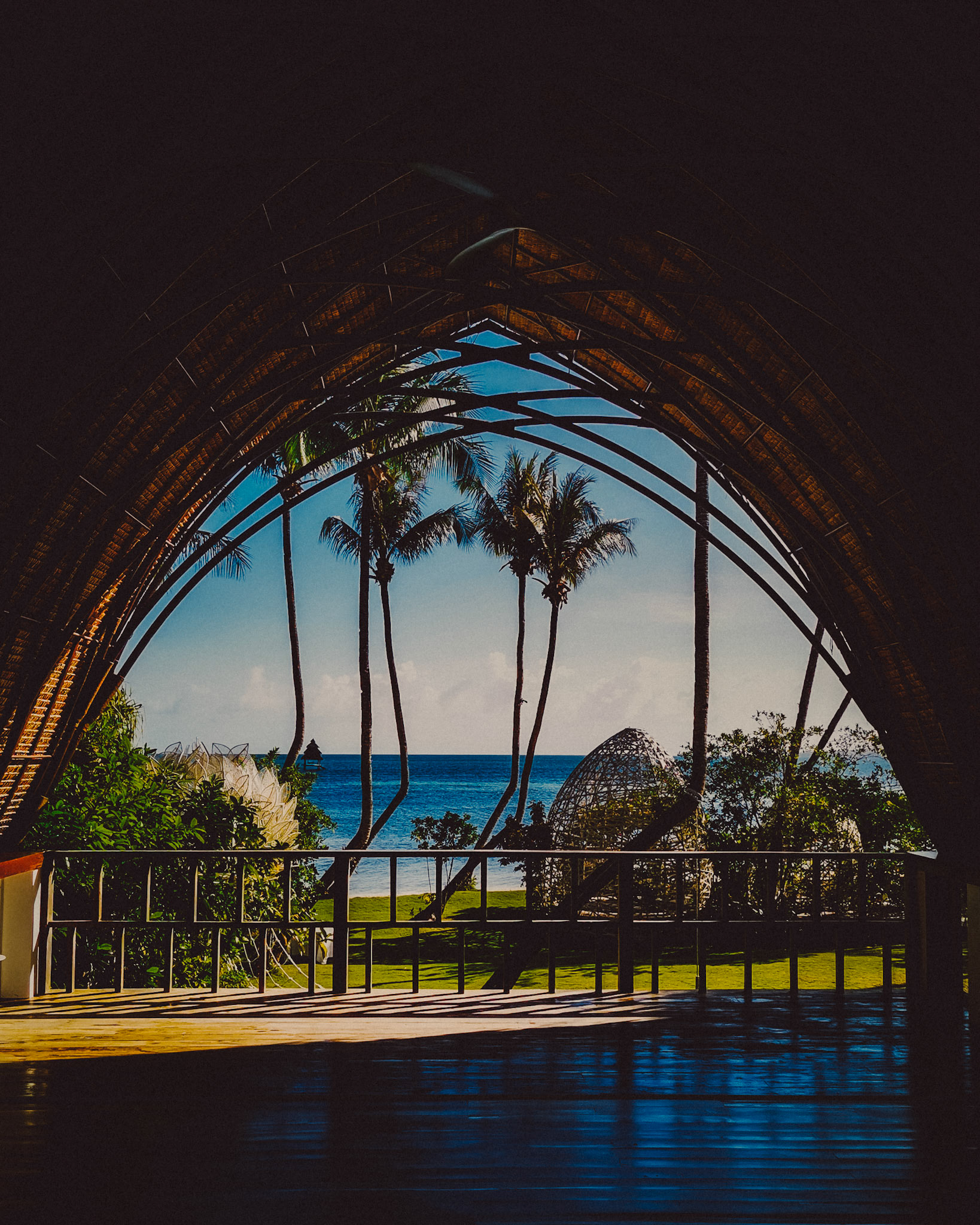 Scenic ocean view with palm trees framed through a native hut, Nay Palad Hideaway, Siargao Island, Philippines, February 2020, Huawei P30 Pro.