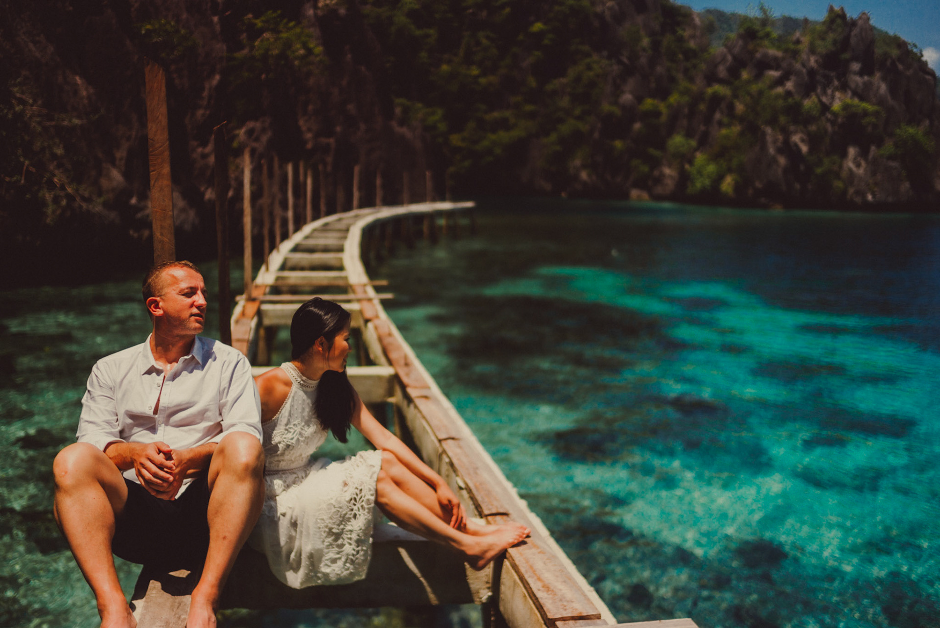 Candid couple photos at the Twin Lagoon's wooden jetty, from Renaud and Kat's island hopping adventure session in Coron, Palawan, Philippines, Southeast Asia, August 2018, Leica M