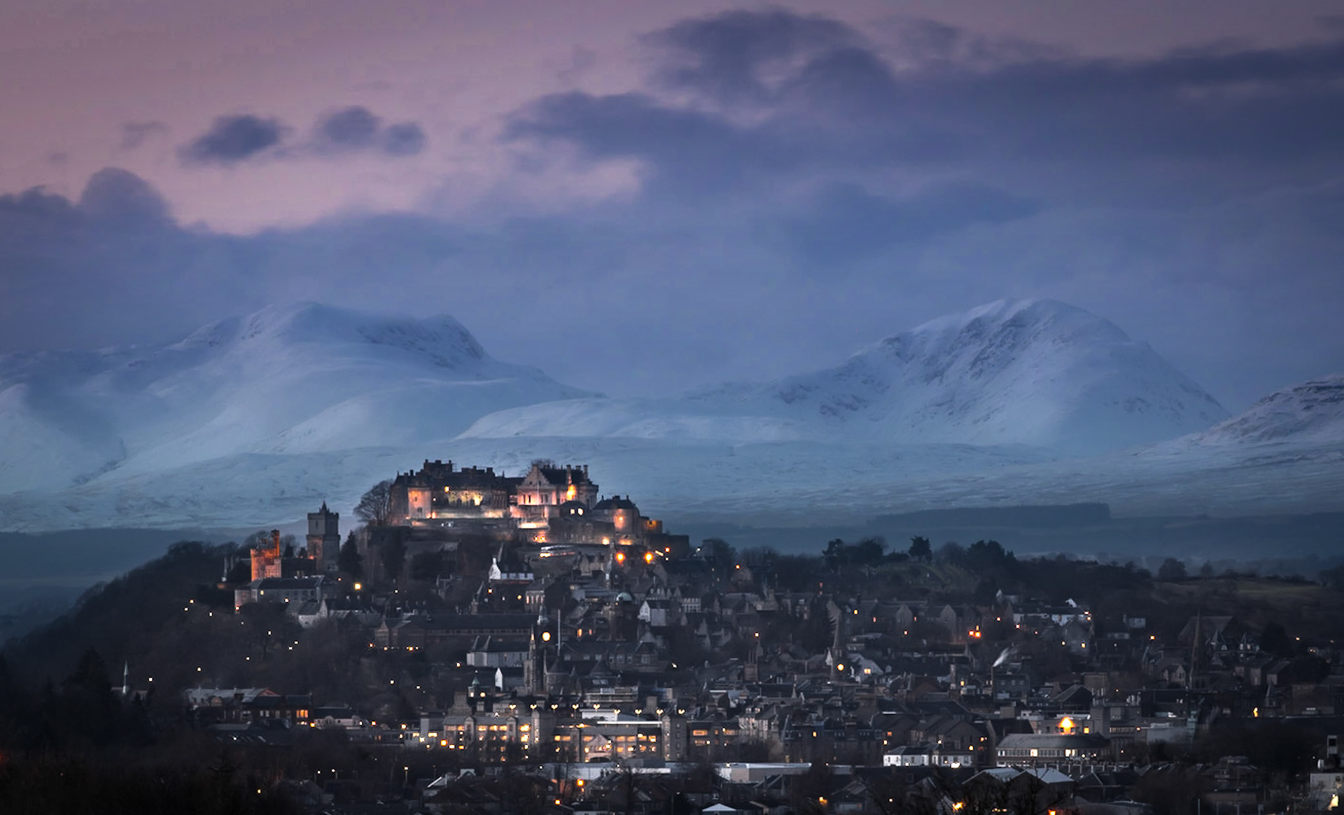 Photograph of Stirling Castle with the snowy mountains in the background.