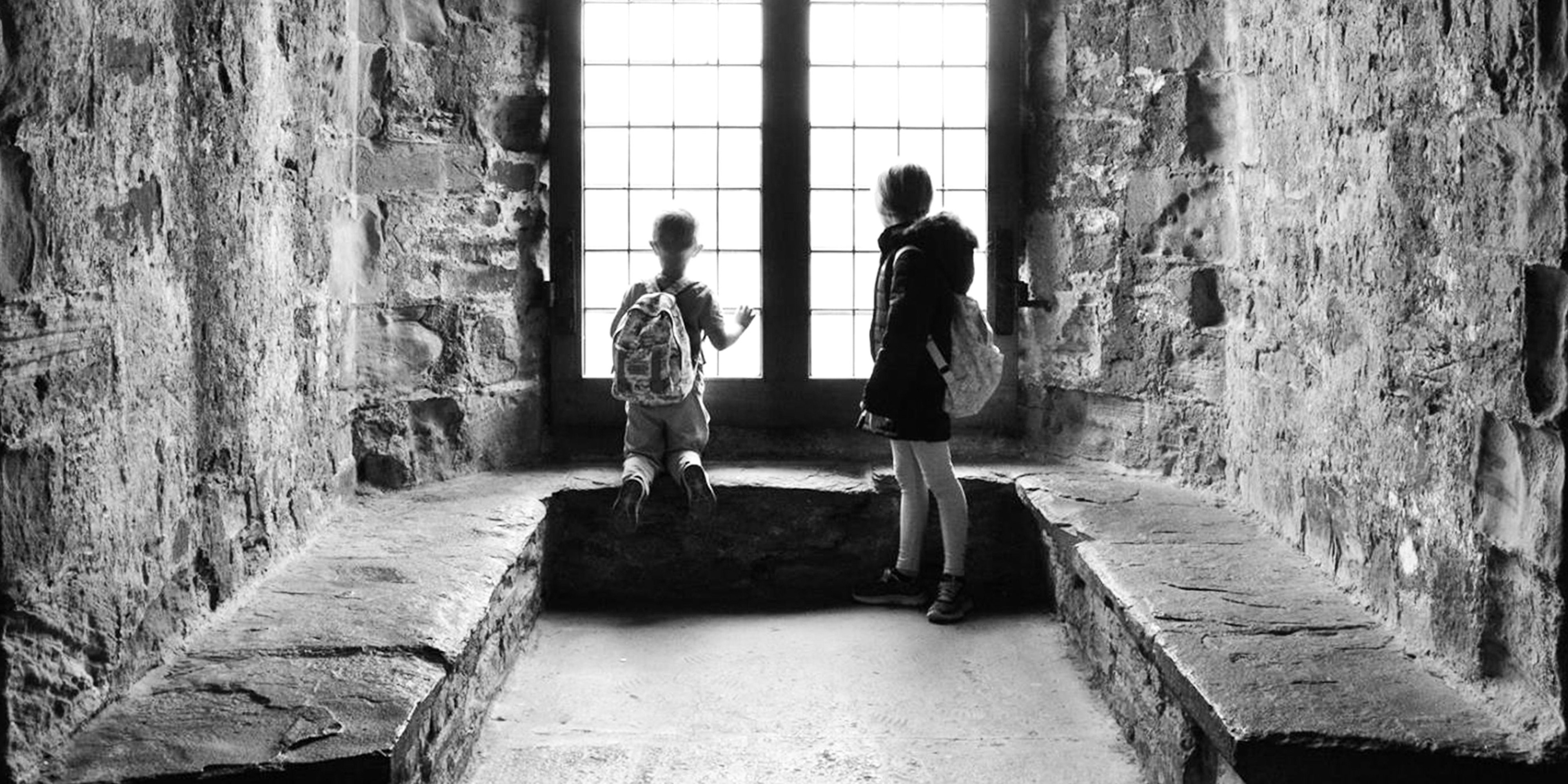 Lindsey L Ahmet graphic designer and photographer main homepage header image of my children looking out of a window at a welsh castle