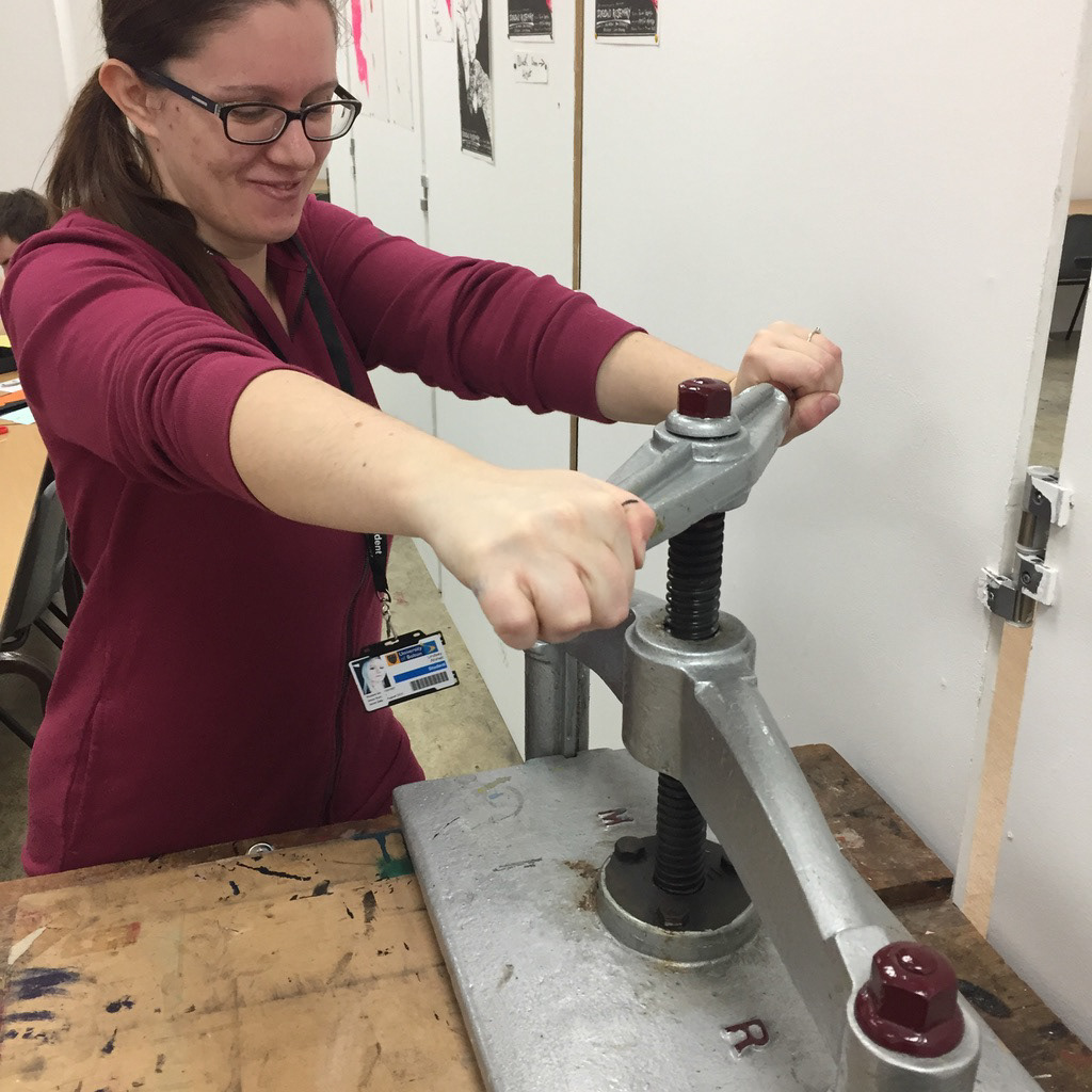 Lindsey L ahmet graphic designer and photographer at university doing woodblock printing