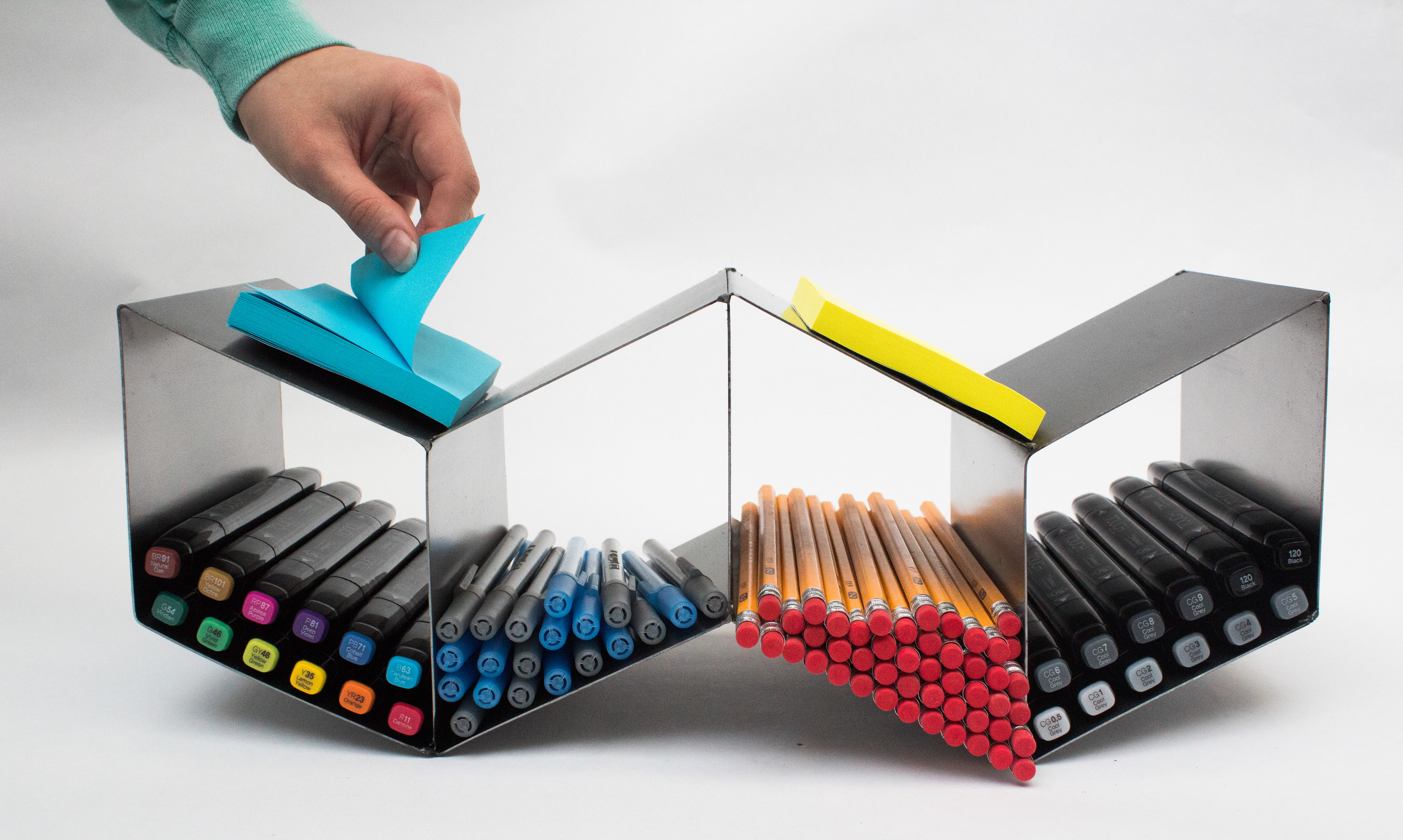 A sheet metal organizer for small writing tools.