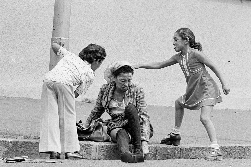Children taunt a homeless woman