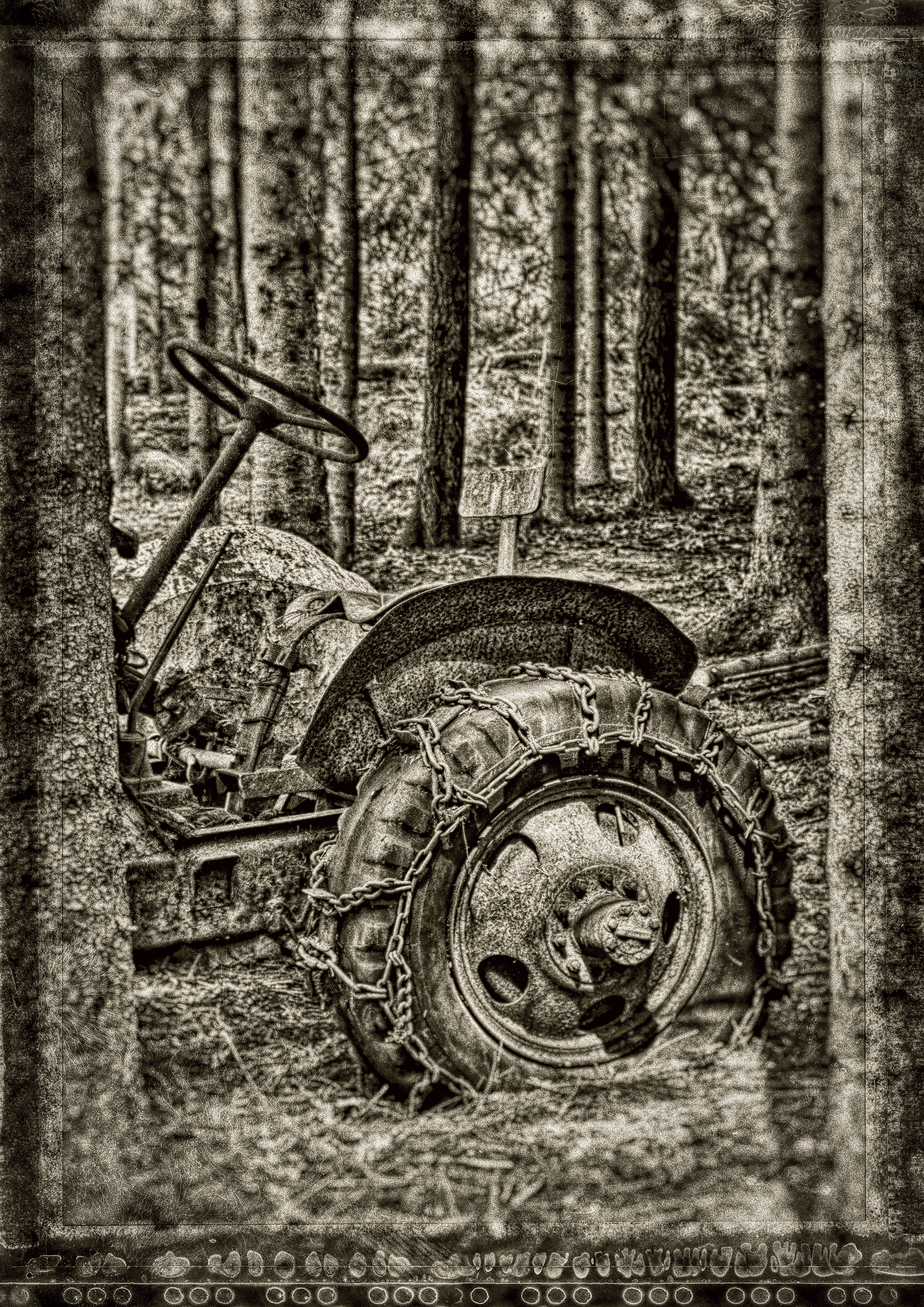 Old abandoned tratyor in the woods. Phoytographed in black and white with border
