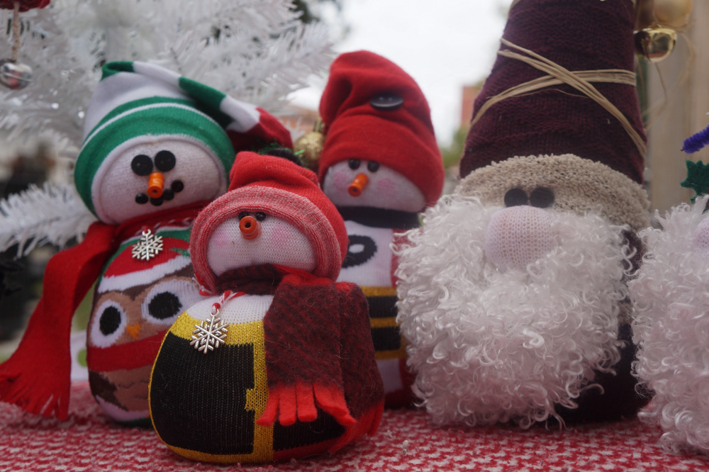 The snowmen and gnomes are made from recycled fabrics such as old socks and leggings. They are then filled with rice to achieve their round shape.