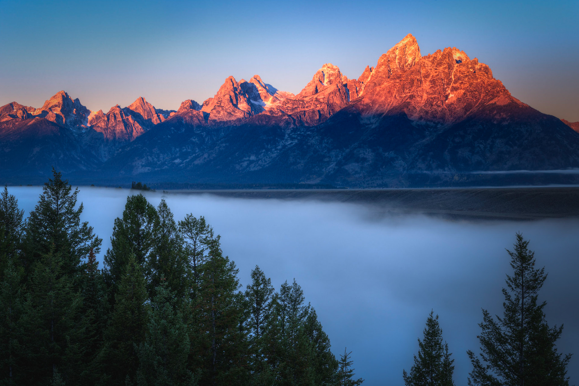 Alpenglow on the Tetons, with the Snake River enveloped in fog.Grand Teton National ParkWyomingSeptember 27, 2016This is an HDR image consisting of 5 exposures merged in Photomatix Pro. Additional processing in Lightroom and Photoshop.PENTAX K-1, TAMRON 28-300mm F3.5-6.3 Ultra zoom XRISO 100 63 mm  ⅛ sec at ƒ / 16