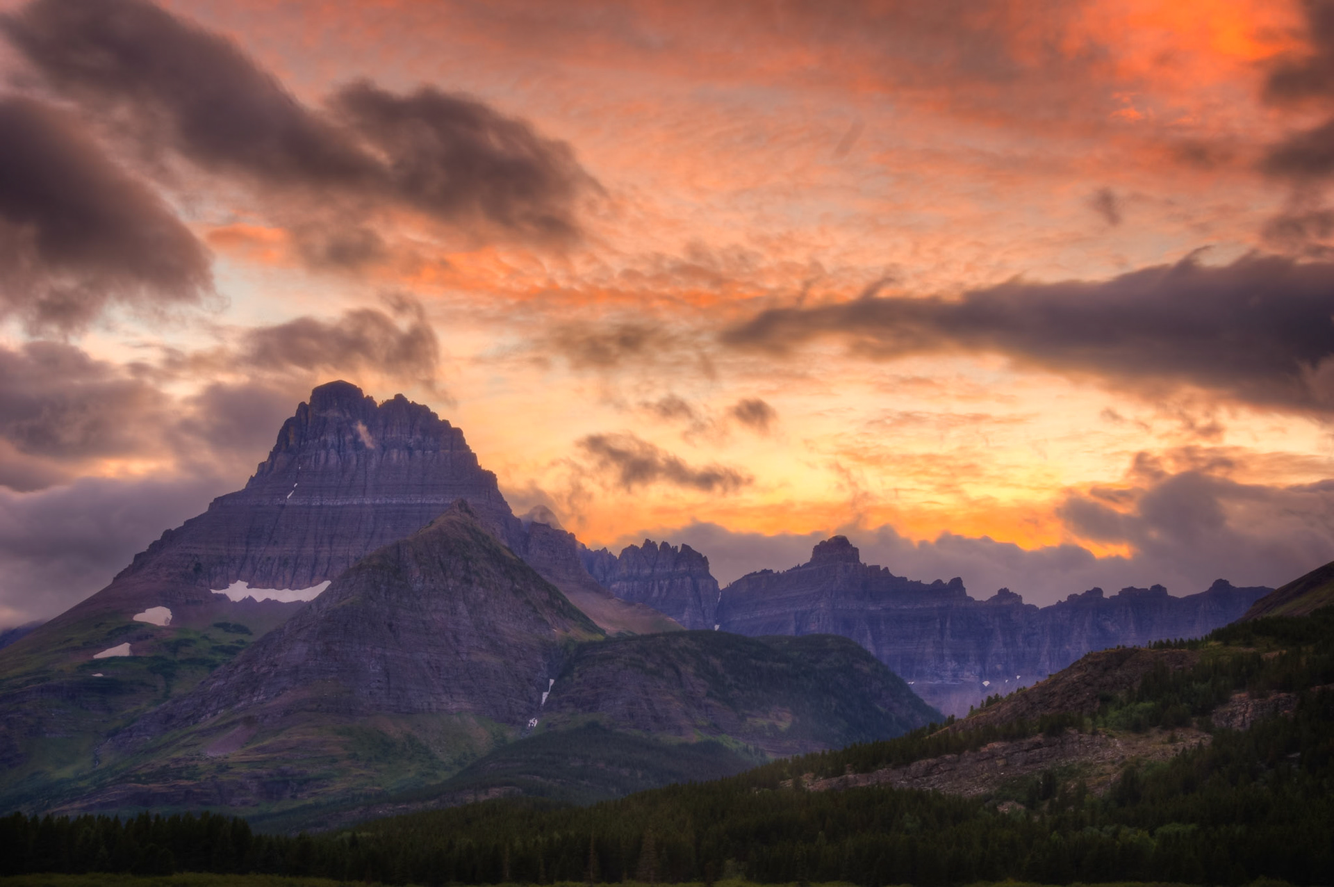 Sunset above Mt. Wilbur and the Ptarmigan Wall, from near the Many Glacier Hotel.Glacier National ParkJuly 27, 2015This is an HDR image consisting of 5 exposures merged in Photomatix Pro. Additional processing in Lightroom and Photoshop.PENTAX K-3, Sigma 18-250mm f/3.5-6.3 DC OS HSMISO 100 37 mm  ⅙ sec at ƒ / 11