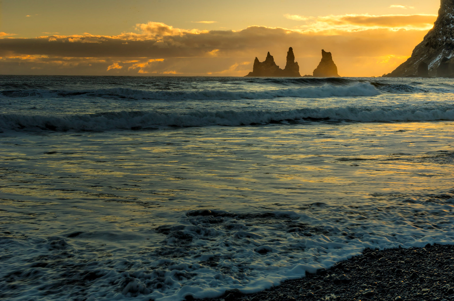 Sunset over the Reynisdrangar sea stacks at the black sand beach in Vík í Mýrdal.Vík, Suðerland, IcelandFebruary 11, 2016This is an HDR image consisting of 5 exposures merged in Photomatix Pro. Additional processing in Lightroom and Photoshop.PENTAX K-3, Sigma 18-250mm f/3.5-6.3 DC OS HSMISO 100 45 mm  ¹⁄₂₅ sec at ƒ / 18