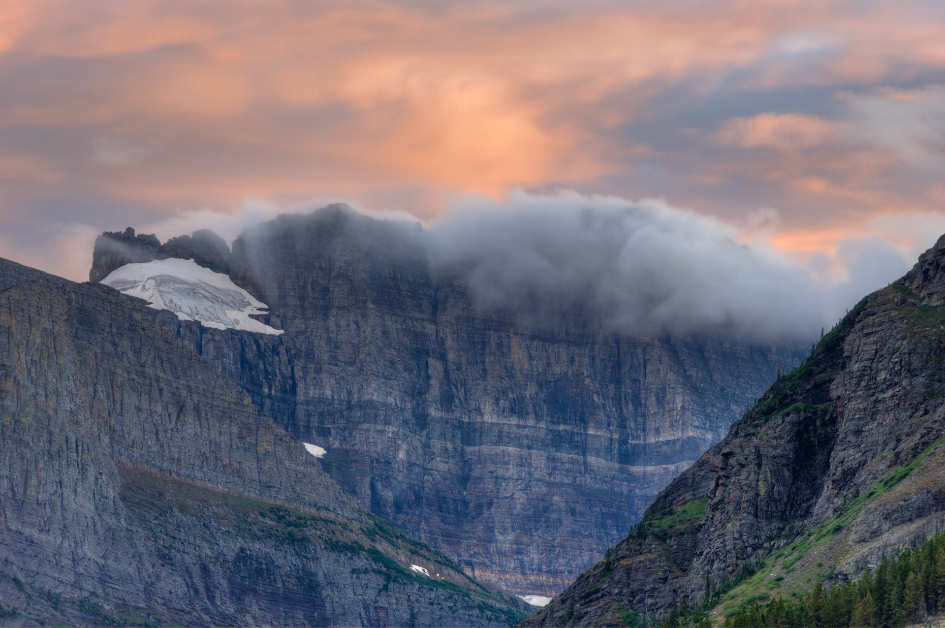 Clouds from a departed storm still clinging to the peaks on the east side of the Garden Wall.Glacier National ParkJuly 27, 2015This is an HDR image consisting of 5 exposures merged in Photomatix Pro. Additional processing in Lightroom and Photoshop.PENTAX K-3, Sigma 18-250mm f/3.5-6.3 DC OS HSMISO 100 148 mm  ¼ sec at ƒ / 11