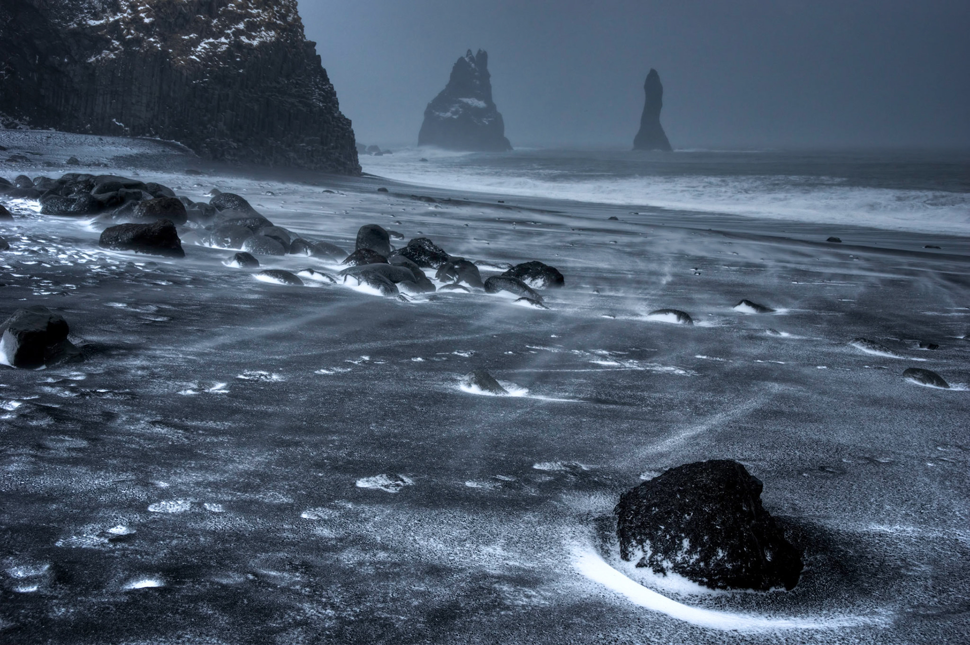 Windblown snow on the black sand beach at Reynisfjara.Suðerland, IcelandFebruary 3, 2016This is an HDR image consisting of 5 exposures merged in Photomatix Pro. Additional processing in Lightroom and Photoshop.PENTAX K-3, Sigma 18-250mm f/3.5-6.3 DC OS HSMISO 400 28 mm  ¹⁄₁₅ sec at ƒ / 9.0