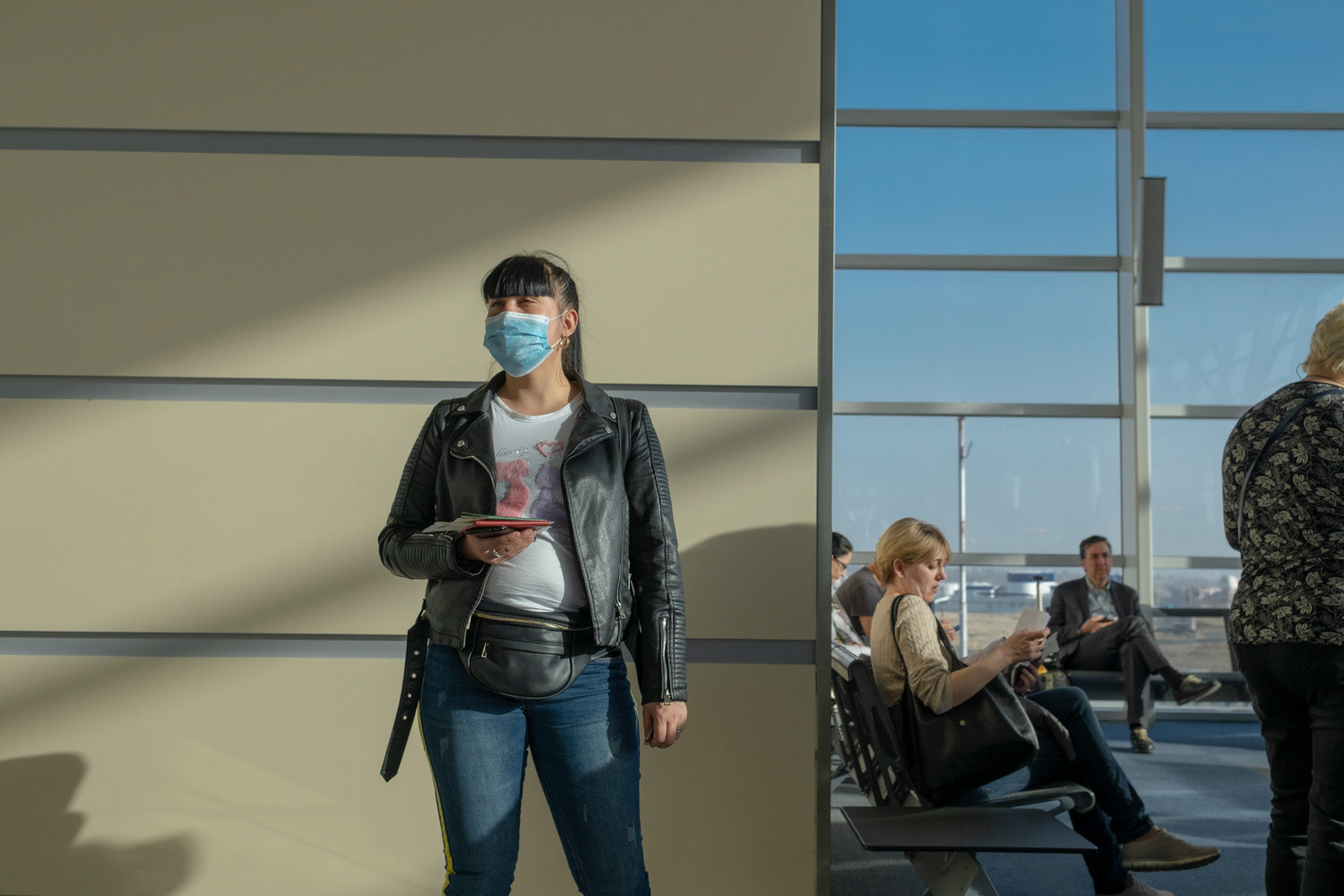 People who wait for their Istanbul flight in Tbilisi Airport in Georgian