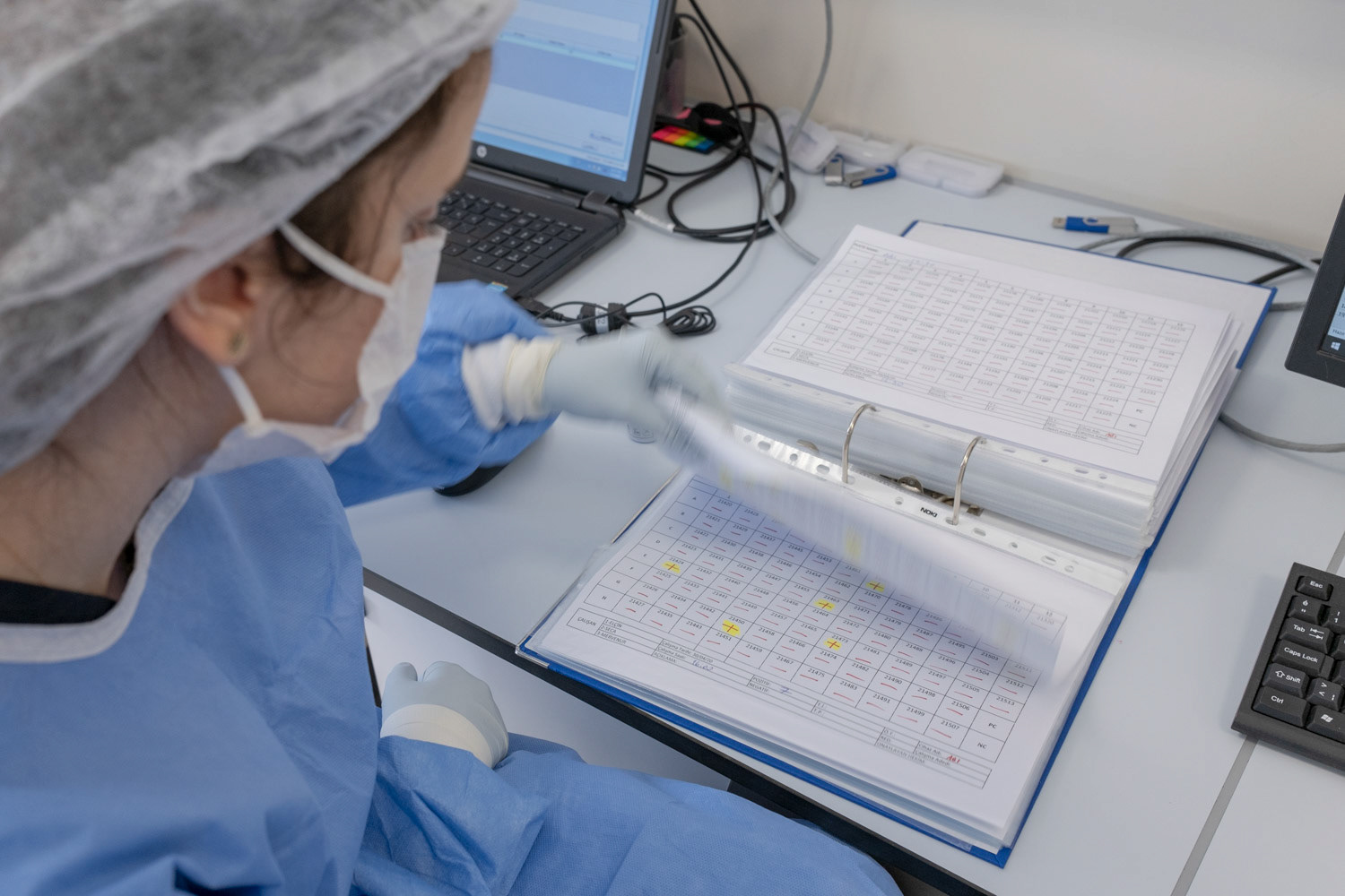 A molecular biologist wearing protective equipments as she interprets the result graphs to decide if there is any viral RNA in samples collected from patient throats and noses at a private laboratory of hospital in Istanbul on 1 May 2020.