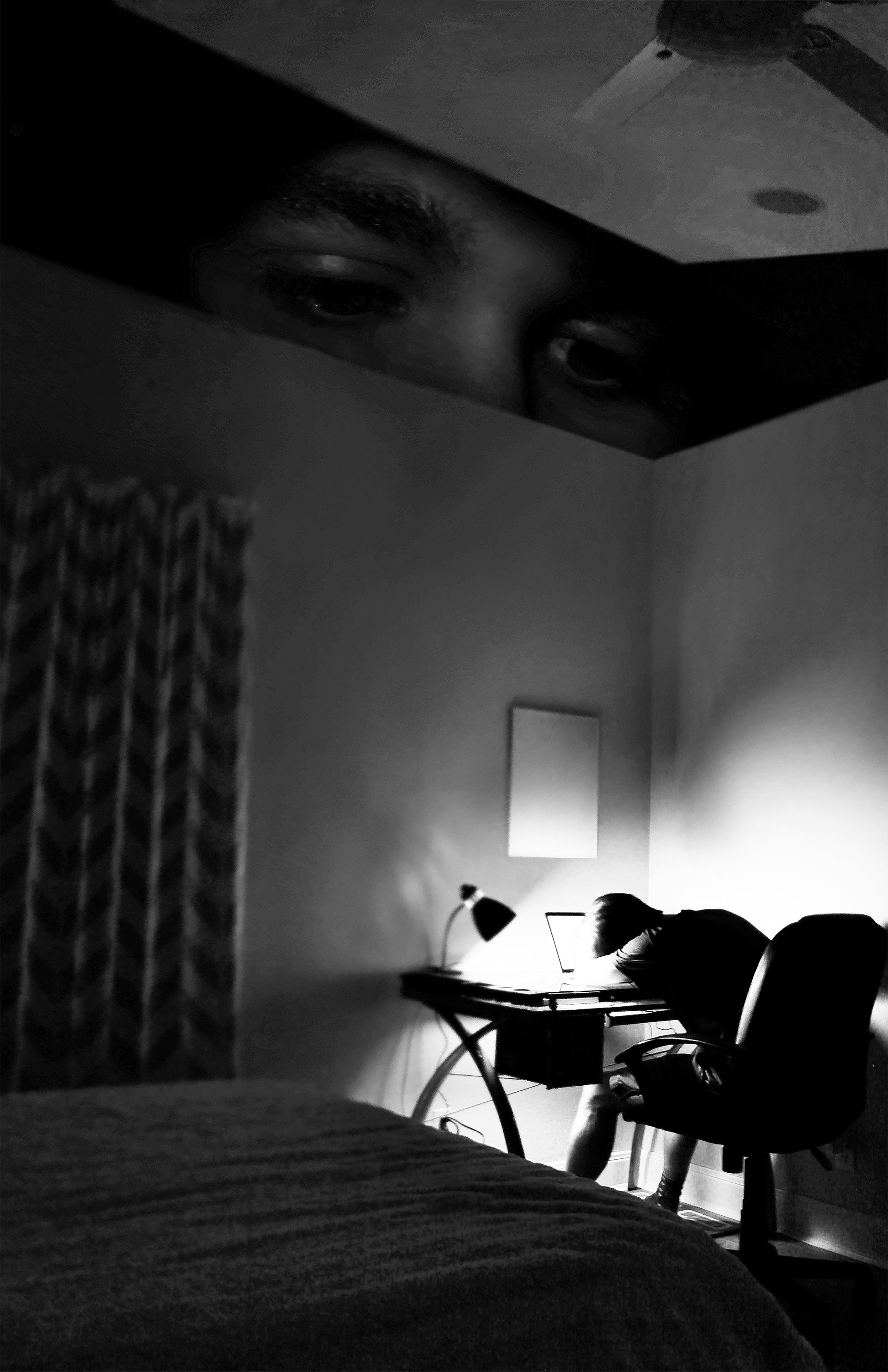 One Way Window  This digital montage represents the emotion of looking back at where a person once was in life and feeling unsatisfied with where they were. It represents the emotion one feels when they are on their road to success look back at what has brought them to their current state. Looking back on struggles they’ve had to handle at points in time, like staying up late to finish a project which can lead to fall asleep at the desk and not finish it. This photo represents the feeling of the future-self wishing they could give advice to the past. It also represents the feeling of regret and wishing that one could go and redo the past.   The photo represents a person opening up a “box,” therefore the “box” is the room which the smaller person is asleep in and the larger person is looking inside the box/room. The box is representation of a memory and the act of opening the box represents actually remembering the memory. The expression of the eyes are an typical expression that one has when they are lost in thought about a potentially regrettable moment.  Taking the photos for this montage was very difficult. I struggled fitting my tripod in the corner of the room trying to capture as much of the room I could. I decided to take the photo horizontally because it made the ceiling and bed elements larger which, to me, brings you more into the room. Those elements remind you that it is a room and a full scene from a memory. When taking the close up of my eyes, I struggled a lot to get a realistic angle. I ended up getting a shoe box and cutting it in half. I placed the camera looking inside the box from the whole, lifted the lid, and took the shot. I then placed them in ps and proceeded to make the image you see now.