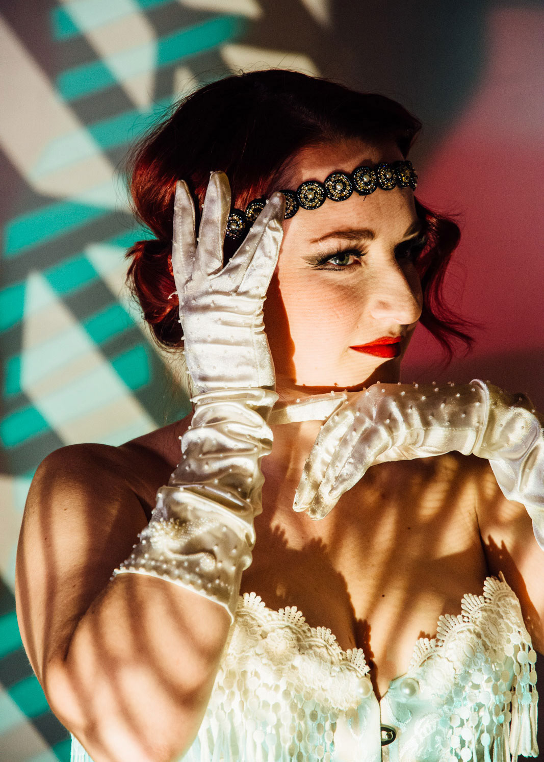 Bettreena Jaeger, singer in High Step Society, strikes a dramatic pose in white dress and gloves