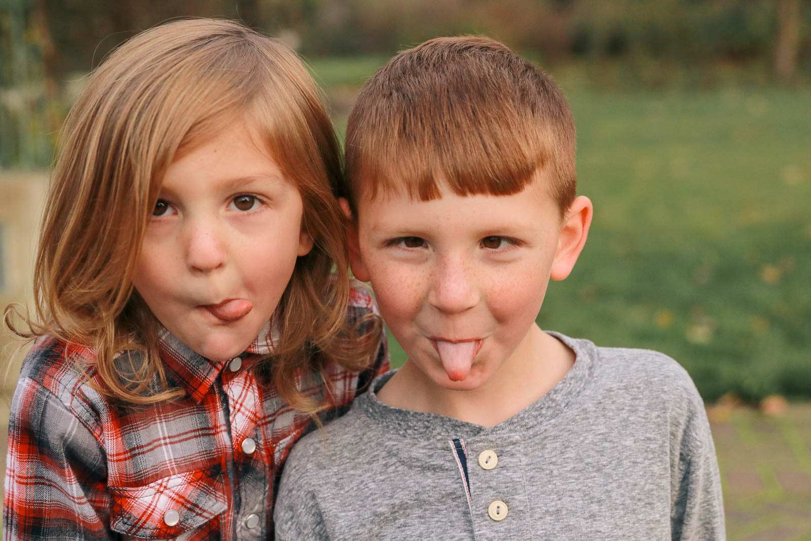 Young brothers goofing off sticking tongues out