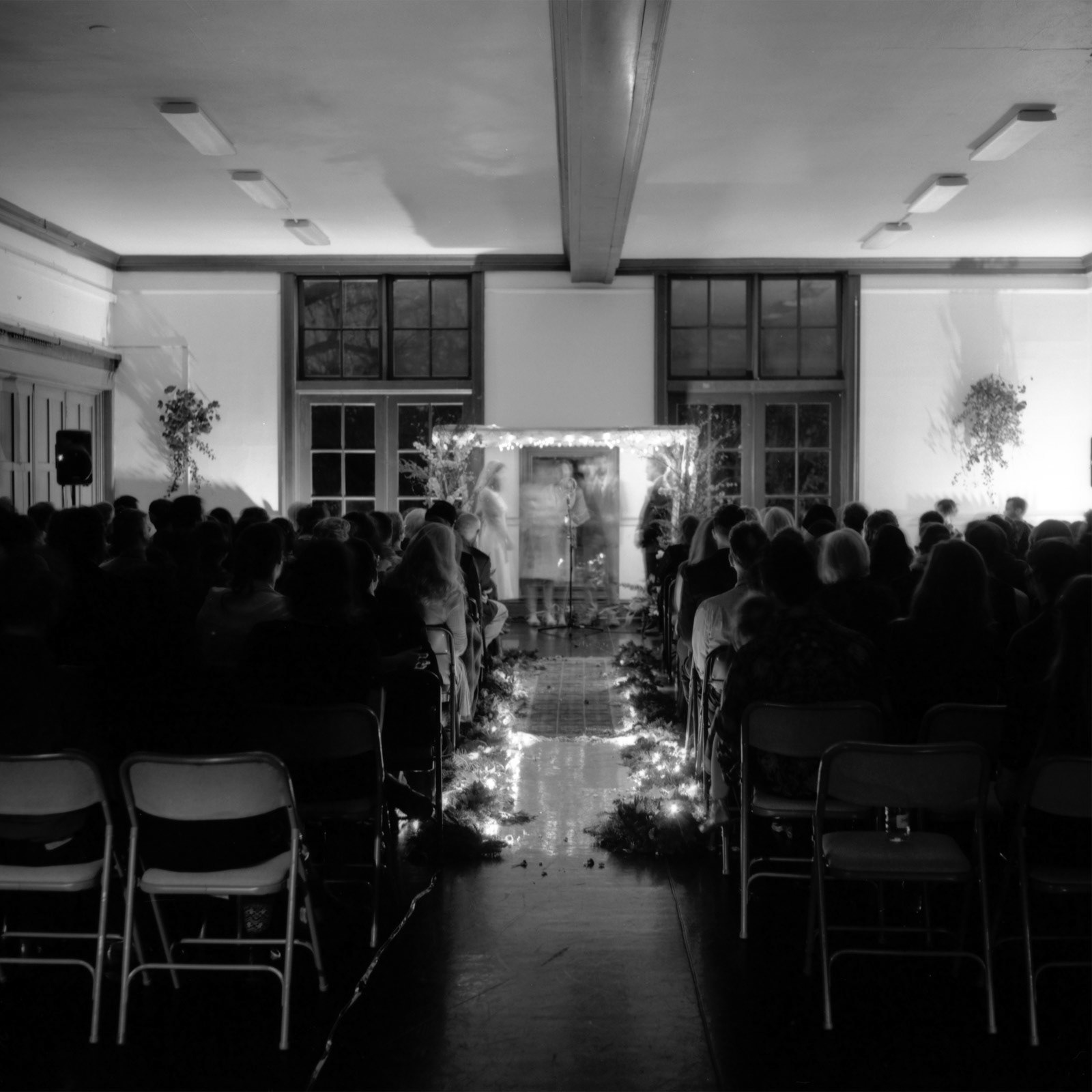 Black and white photograph of night time ceremony