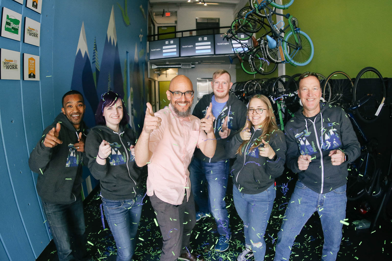 Team of IDX workers celebrating their company