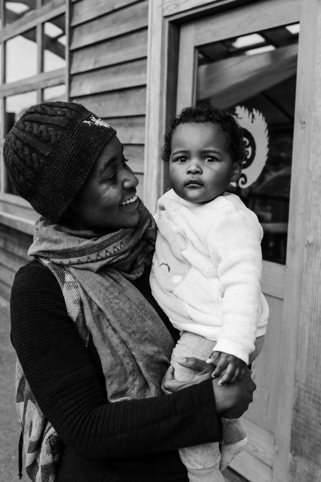 Close look of baby's face and eyes being held by mother