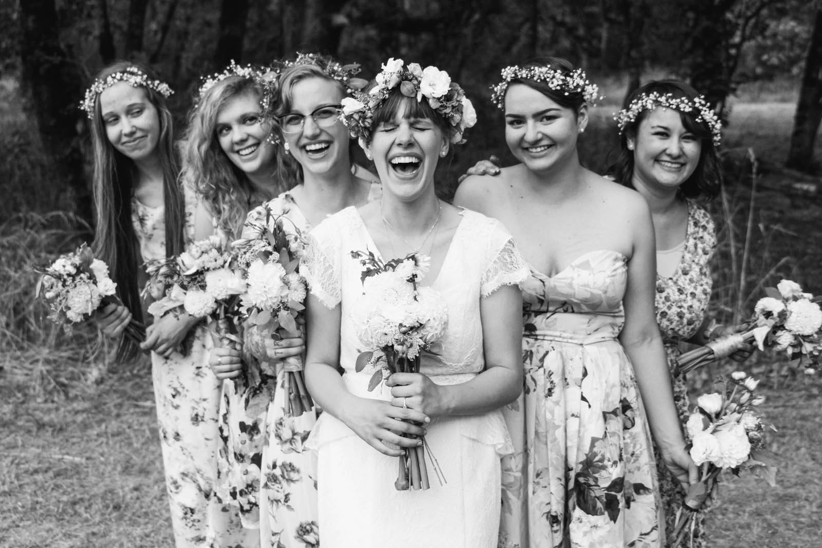 Bride among bridesmaids all holding flowers