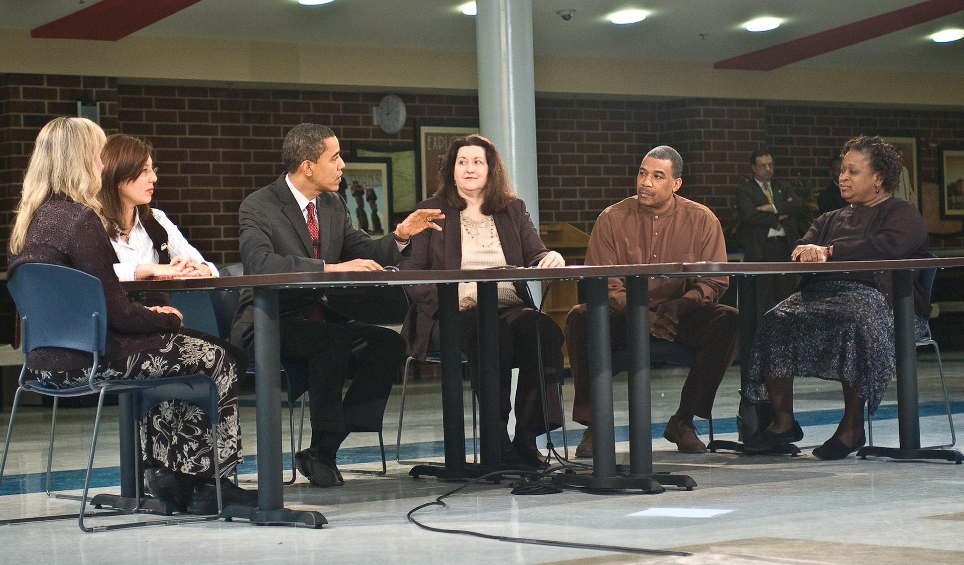 Senator Obama speaks and listens to participants at a round table discussion of education at T.C. Williams High School. From left are Kate Maliga, Ana Bonilla, Obama, Ronnie Campbell, Stuart Thompson, and Karen Parker Thompson, February 10, 2008.