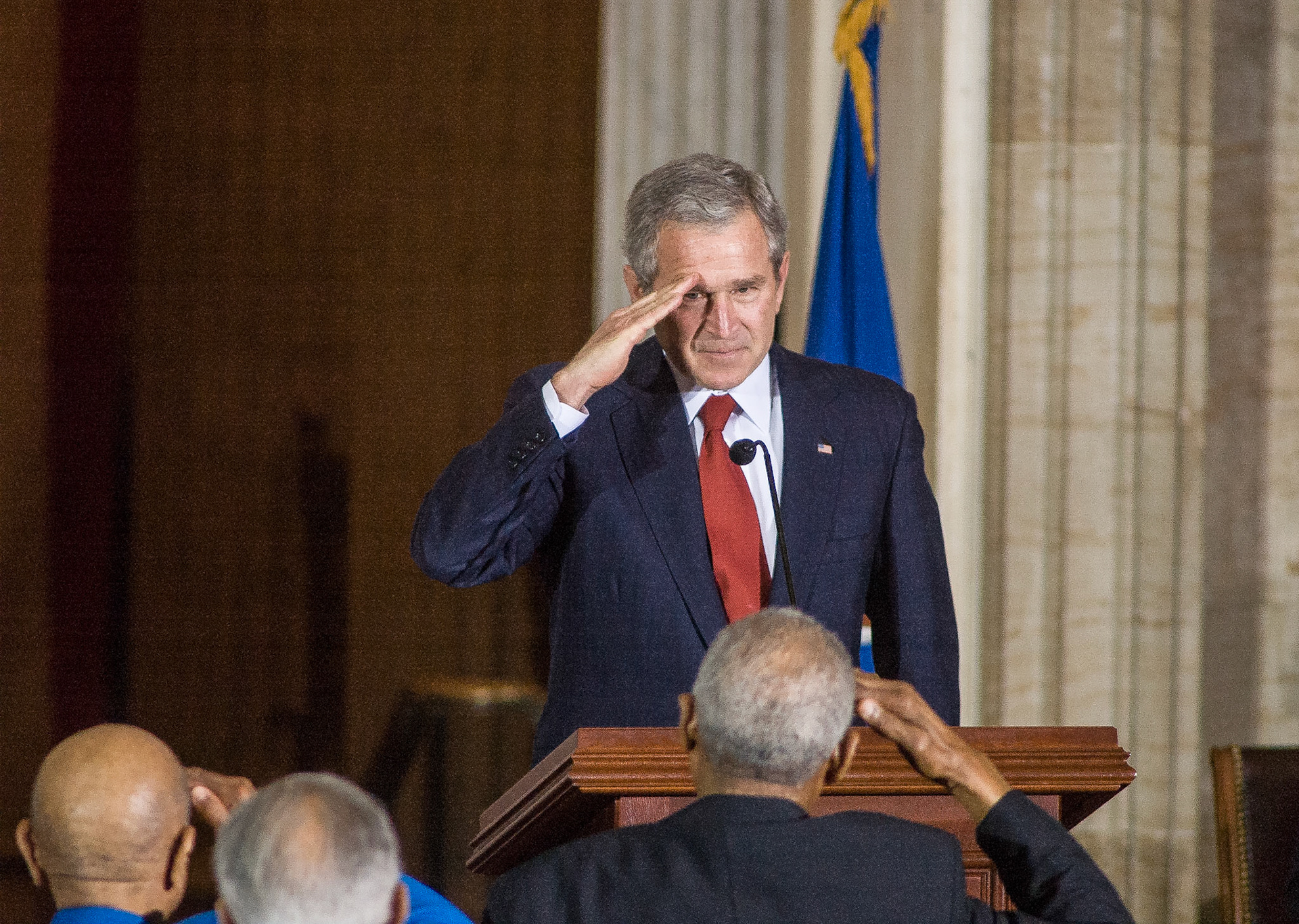 President George W. Bush exchanges salutes with the Tuskegee Airmen following his speech, March 29, 2007.