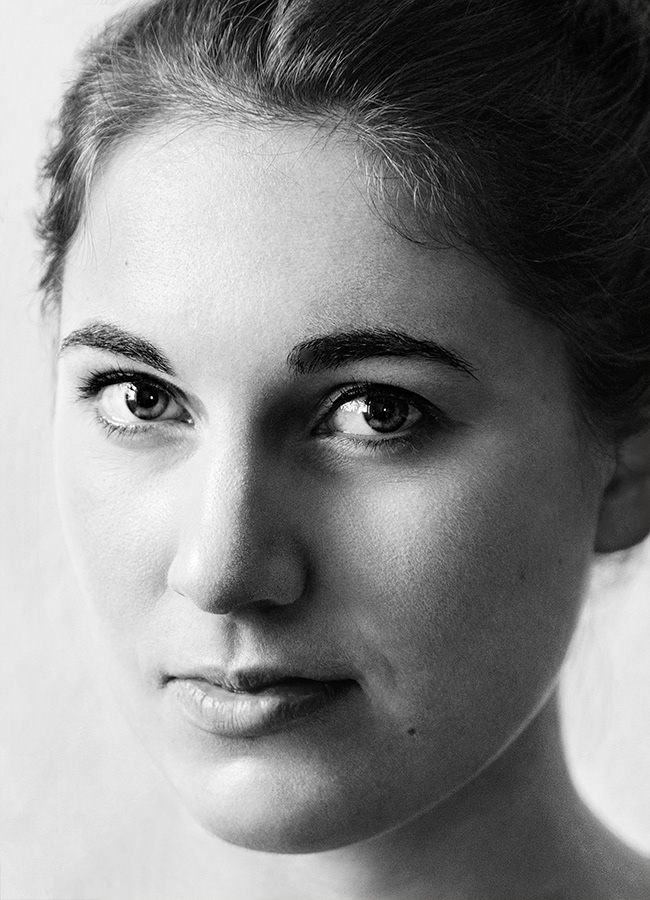 nahaufnahme klassisches sw portrait. junge frau. lächelt geheimnisvoll