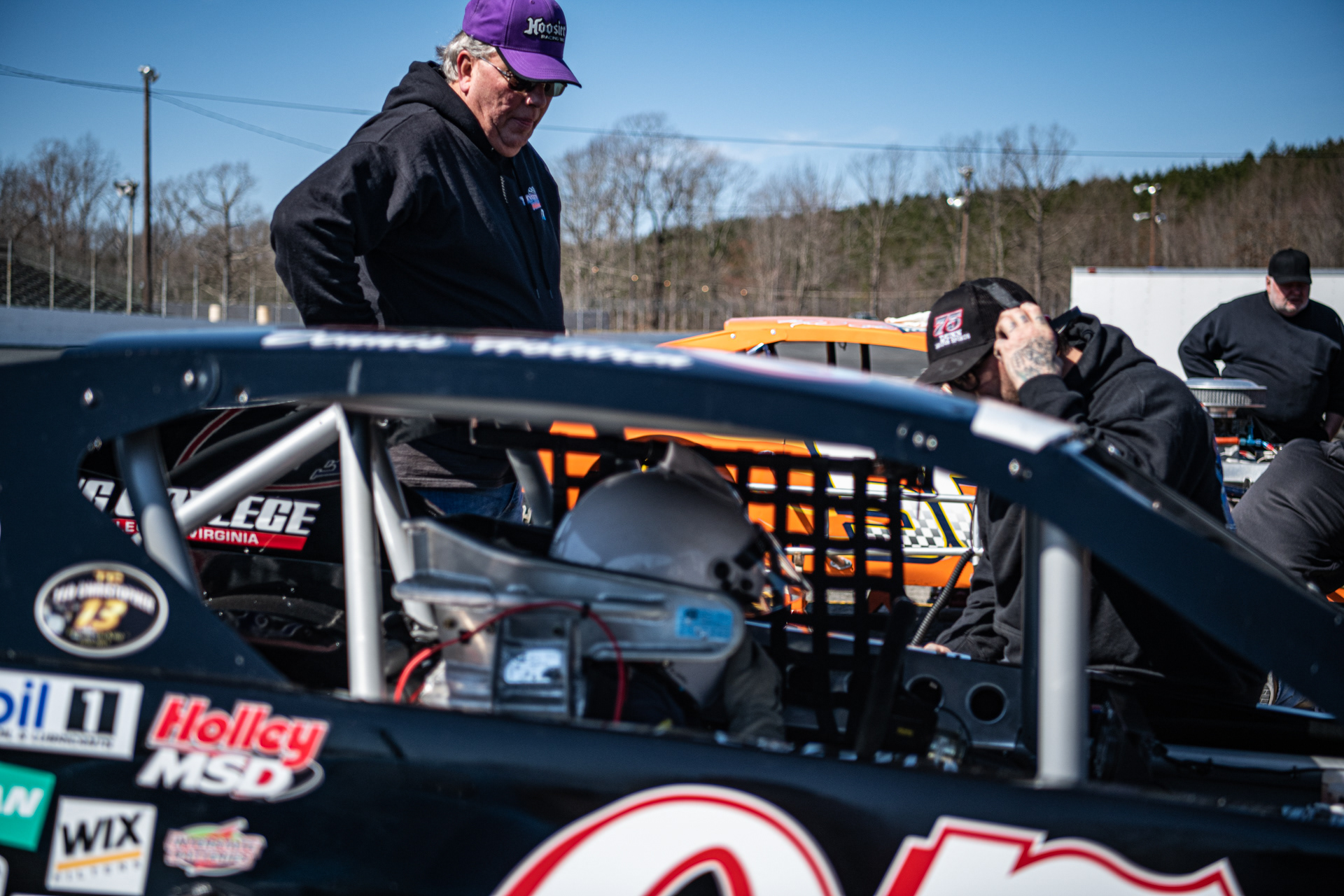 Bradly Eubanks (right), Dennis Holdren (middle), and Mark Dowdy test their radios before going into the track for open testing at Caraway Speedway in Sophia, N.C. on March 6, 2021.