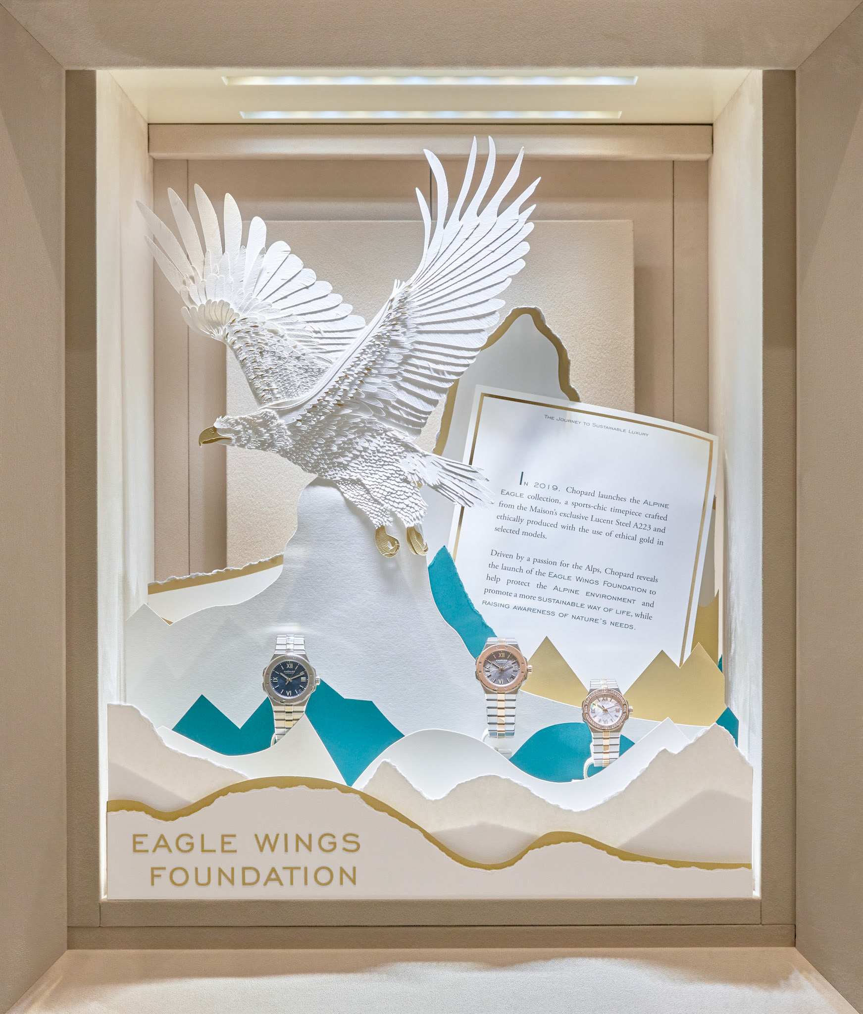 retail photography chopard ethical gold window display eagle wings foundation