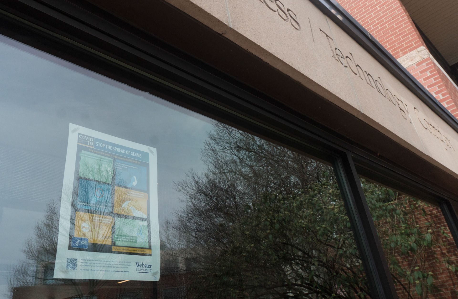 An informational poster hangs in the window of the Sverdrup Complex, 6300 Big Bend Blvd., on March 27, 2020.