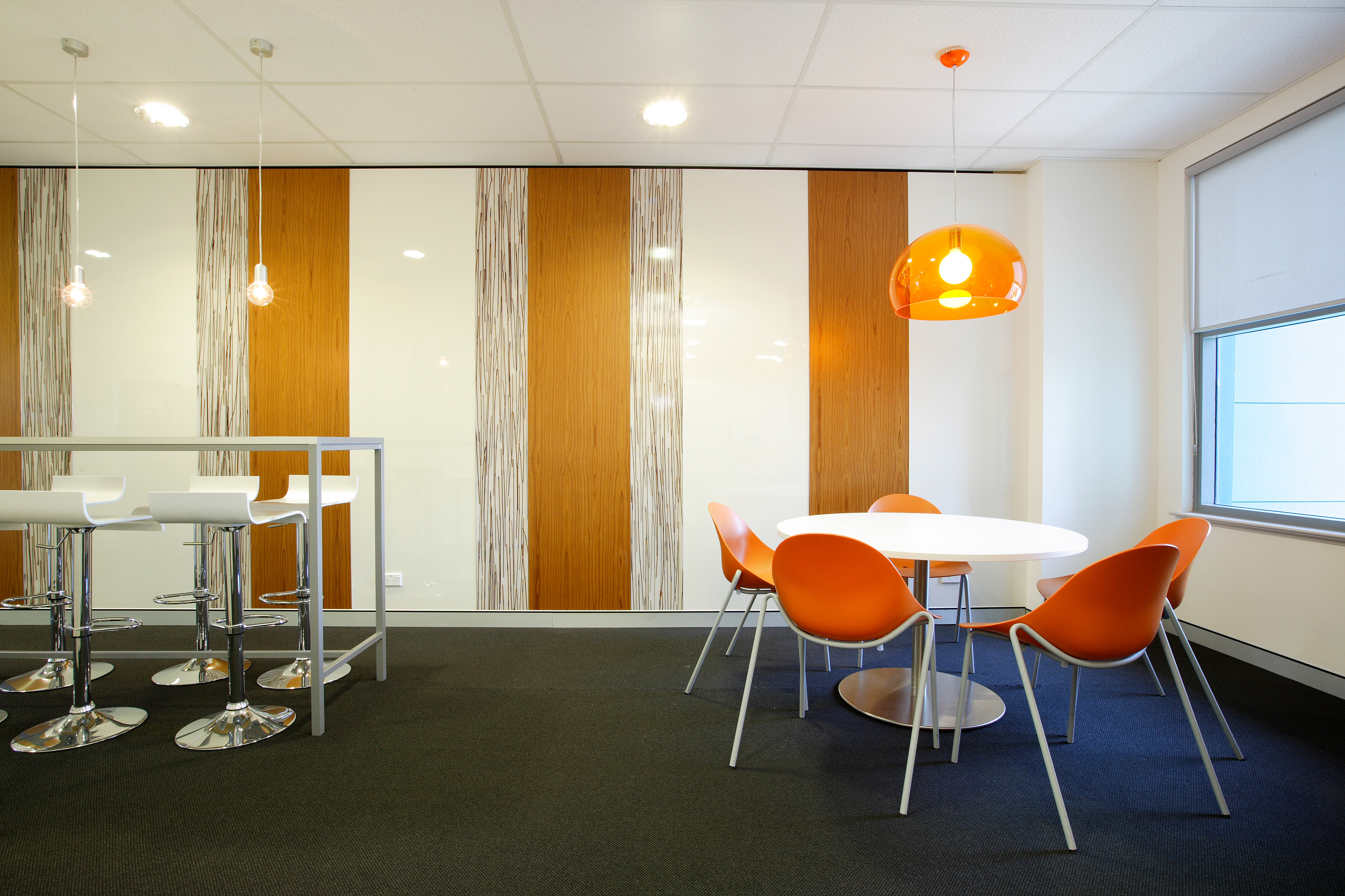 Breakout space with low and high seating options, and soft lighting