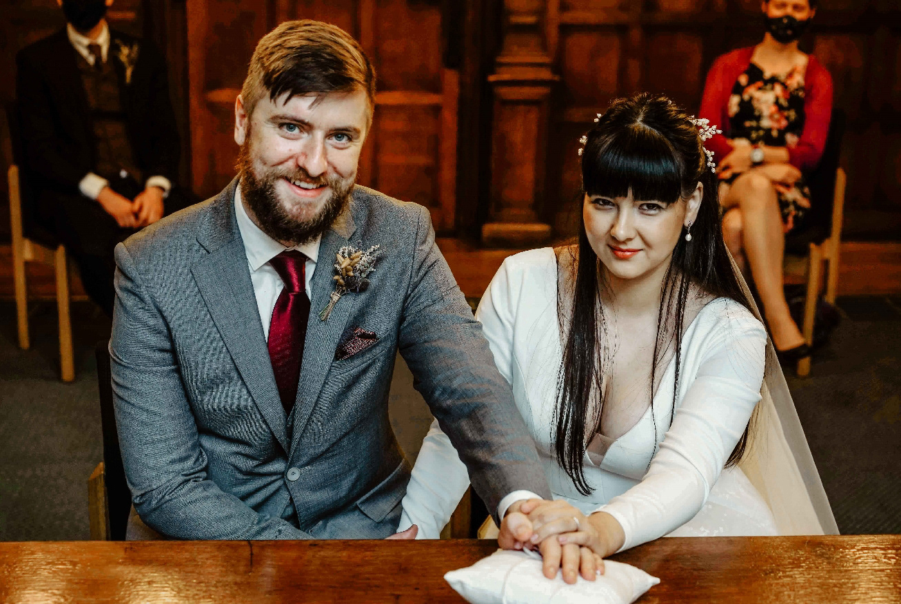 happily married couple sat in intimate covid wedding in december in oxford town hall taken by wedding photographer david lefebvre